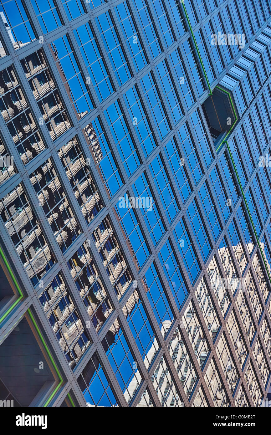Two buildings reflected on nearby skyscraper Stock Photo