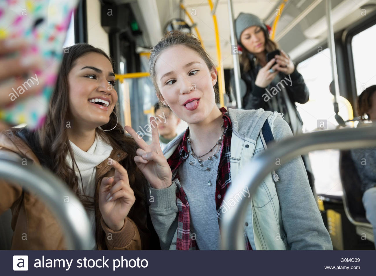 Teenage girl making a face taking selfie bus Stock Photo
