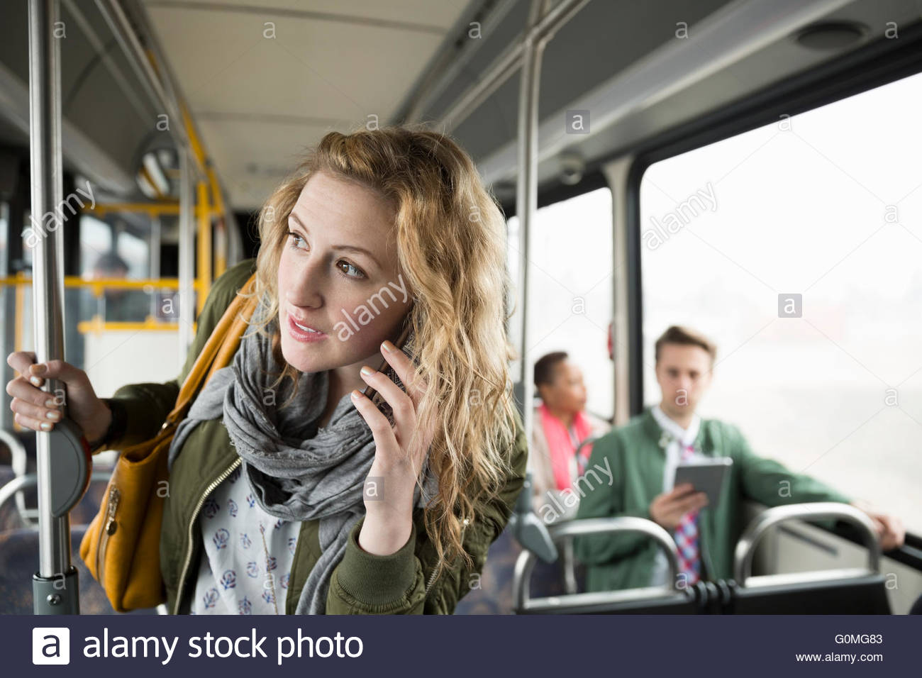 Woman talking on cell phone on bus Stock Photo