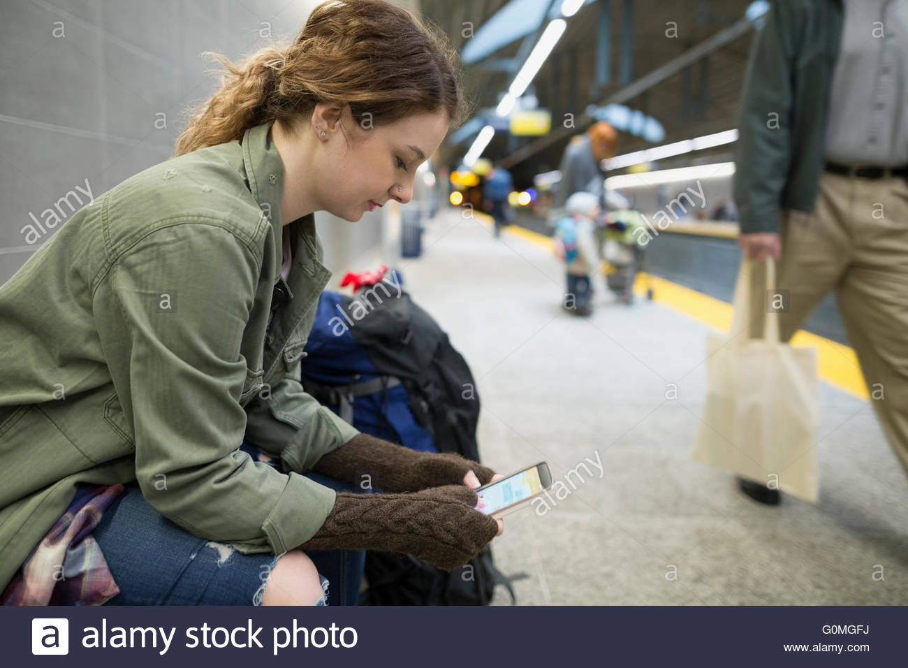 Woman texting with cell phone subway station platform Stock Photo Alamy