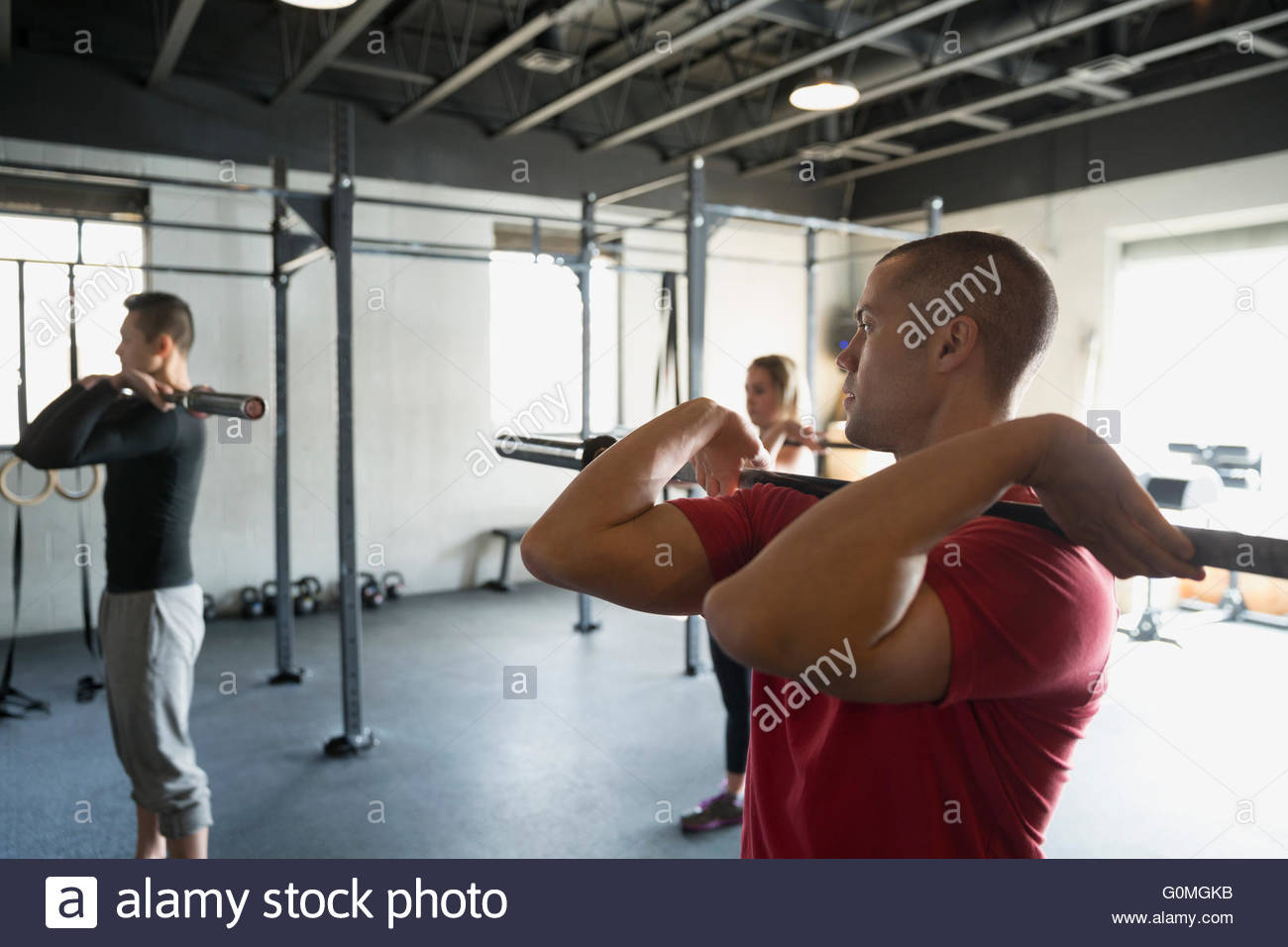 Man with barbell in exercise class Stock Photo Alamy