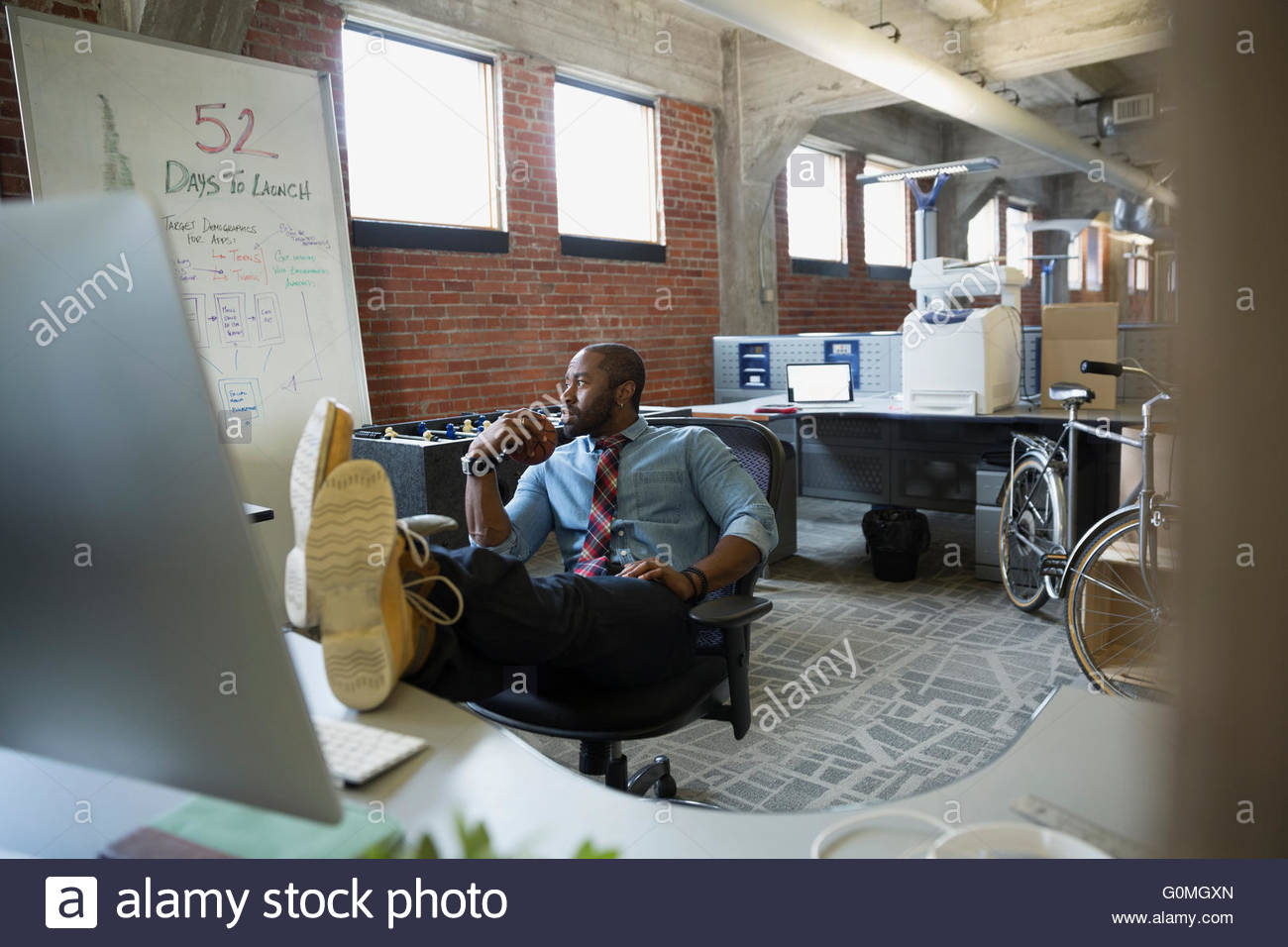 Entrepreneur with feet up on desk new office Stock Photo