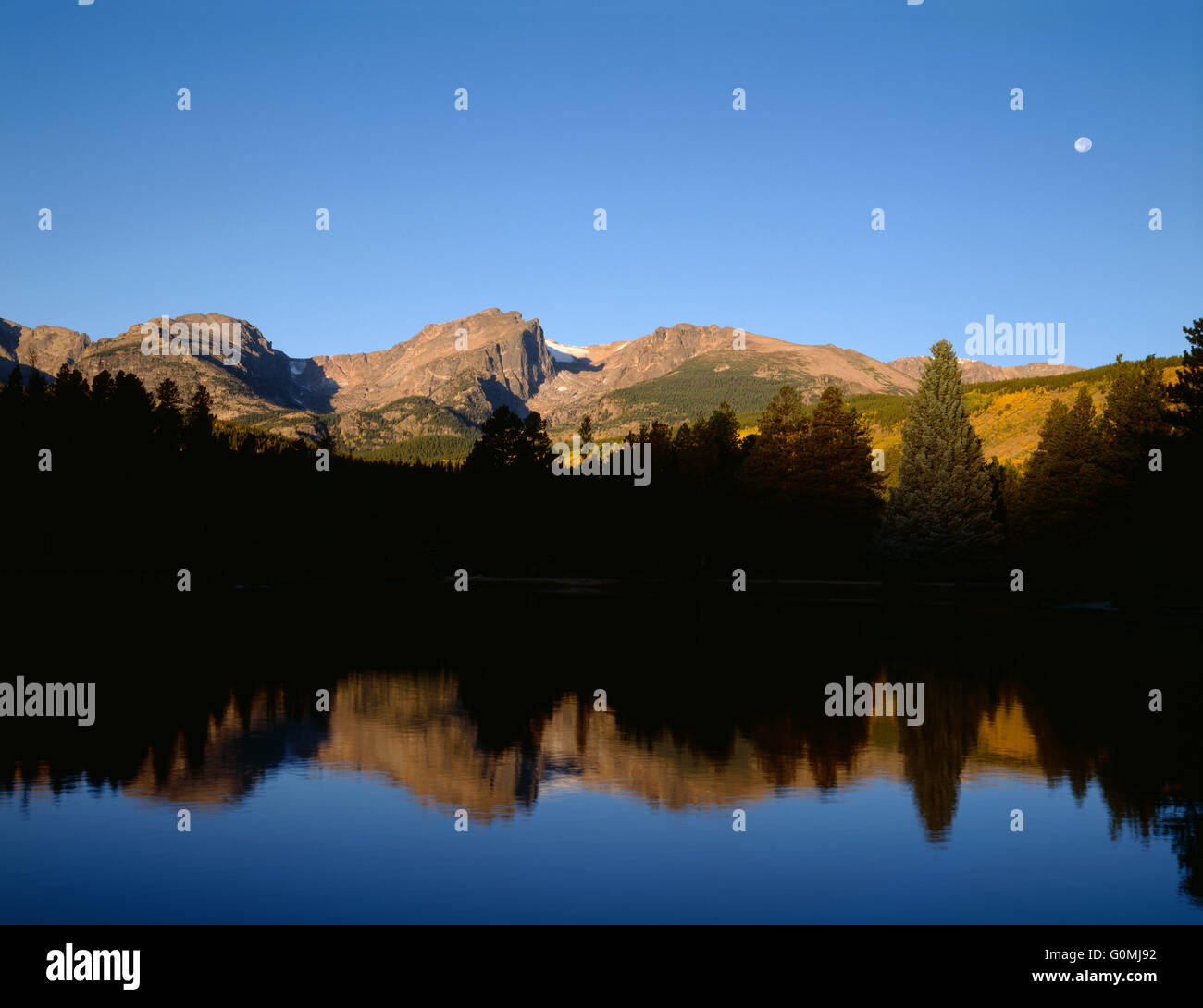 USA, Colorado, Rocky Mountain National Park, Hallett Peak reflects in Sprague Lake at sunrise. Stock Photo