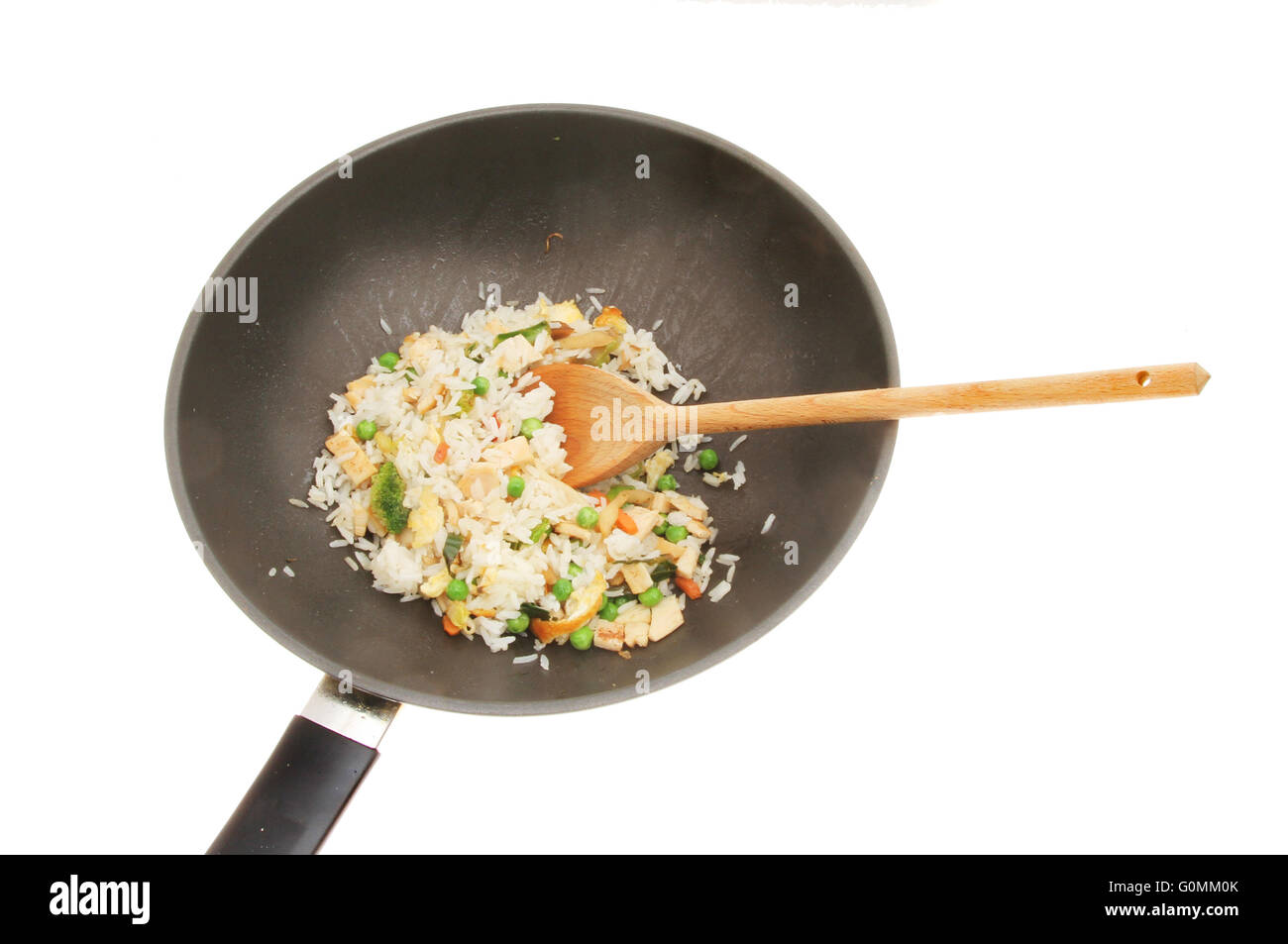 Fried rice in a wok with a wooden spoon isolated against white Stock Photo
