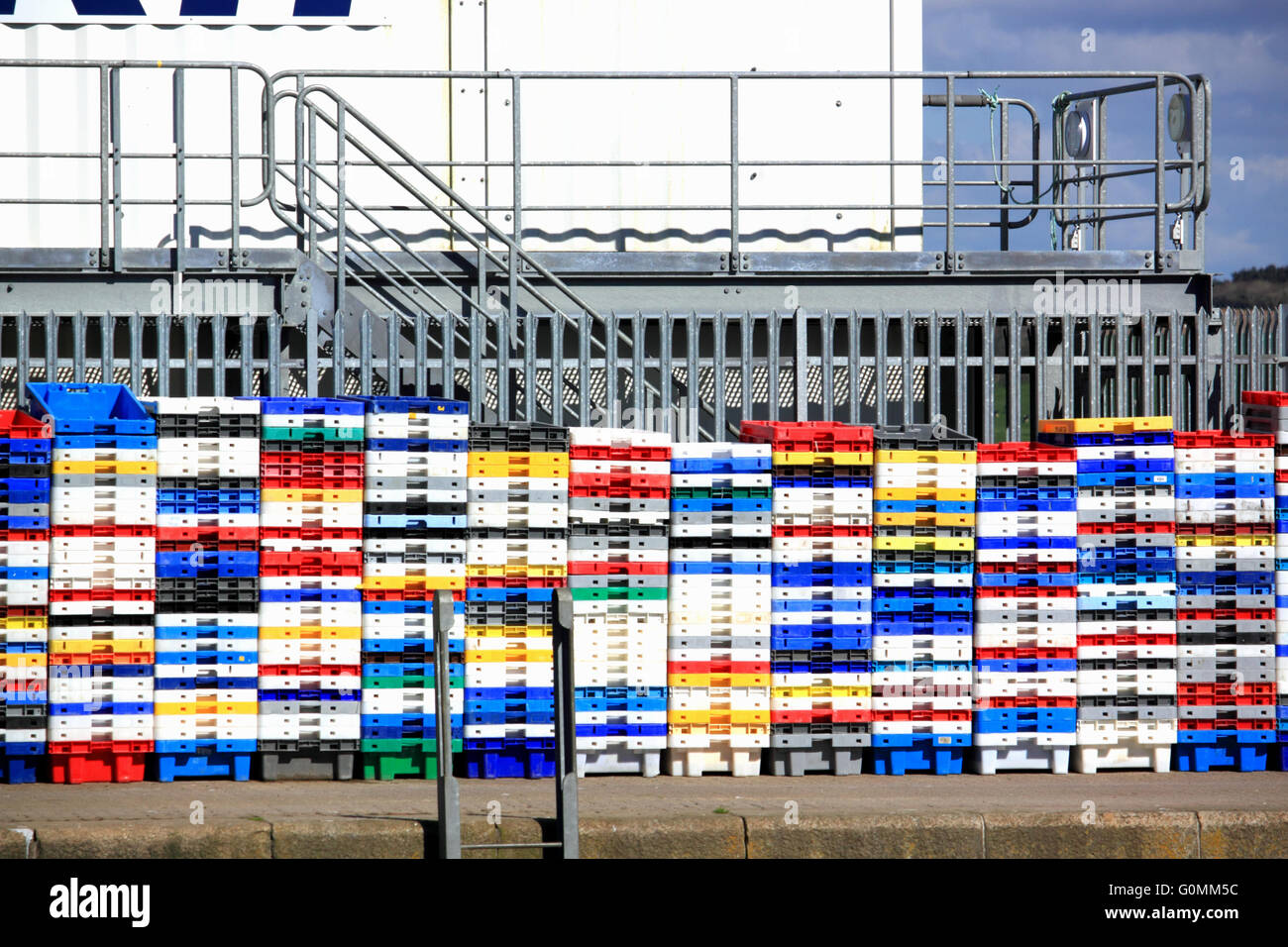 Empty fish boxes stacked on the quayside at Padstow, Cornwall. Stock Photo