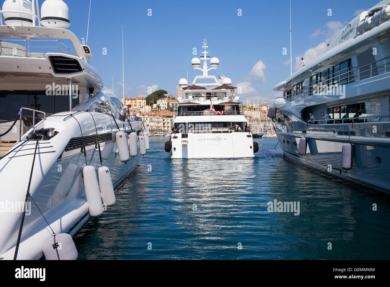 Luxury yachts moored at Cannes, France. The old town of Le Suquet is in the background. Stock Photo