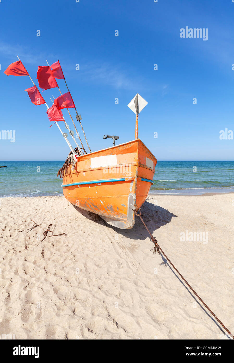 Small fishing boat on a beach in Rewal, Poland. Stock Photo