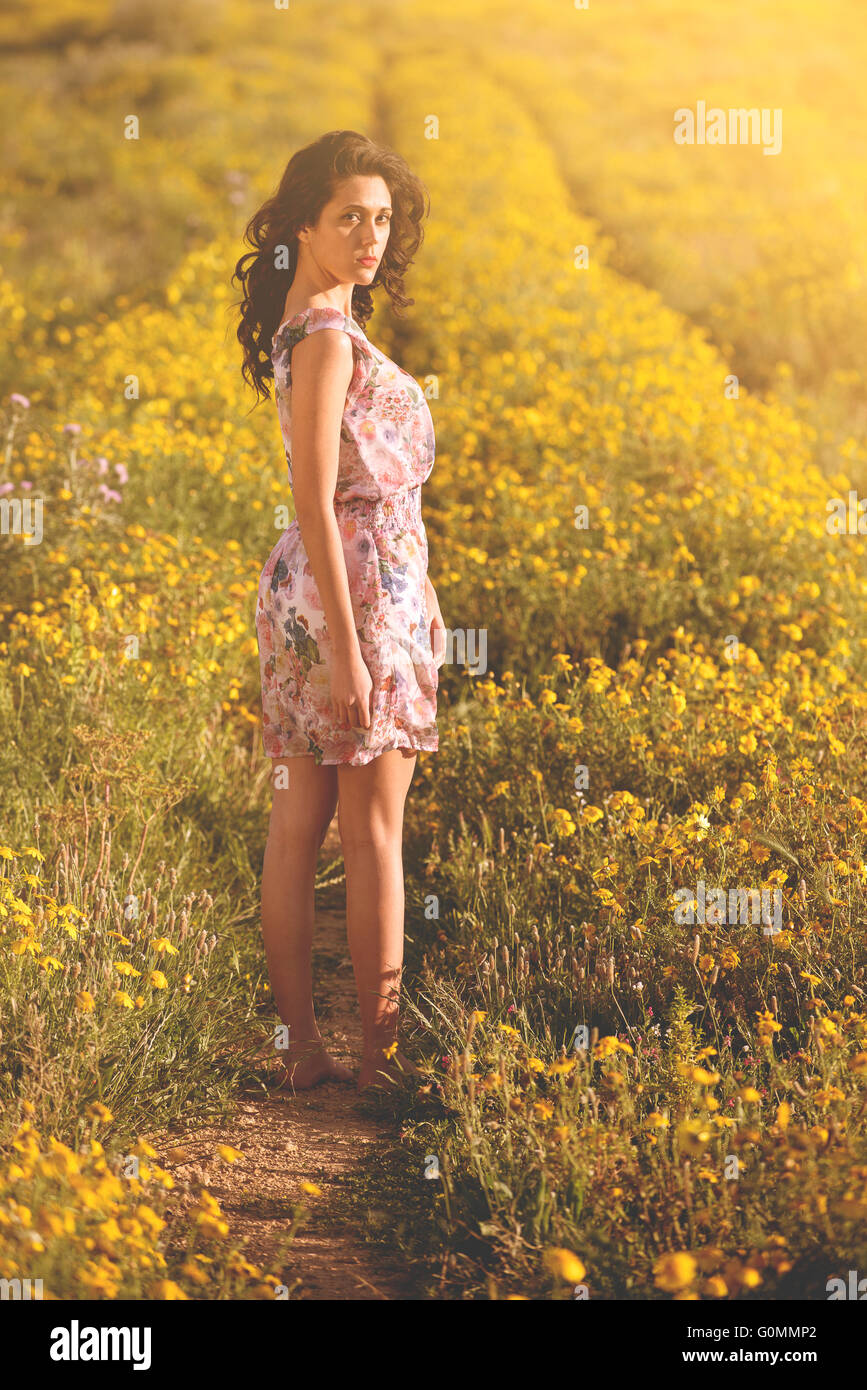 portrait of a beautiful girl in the spring in the middle of daisies Stock Photo