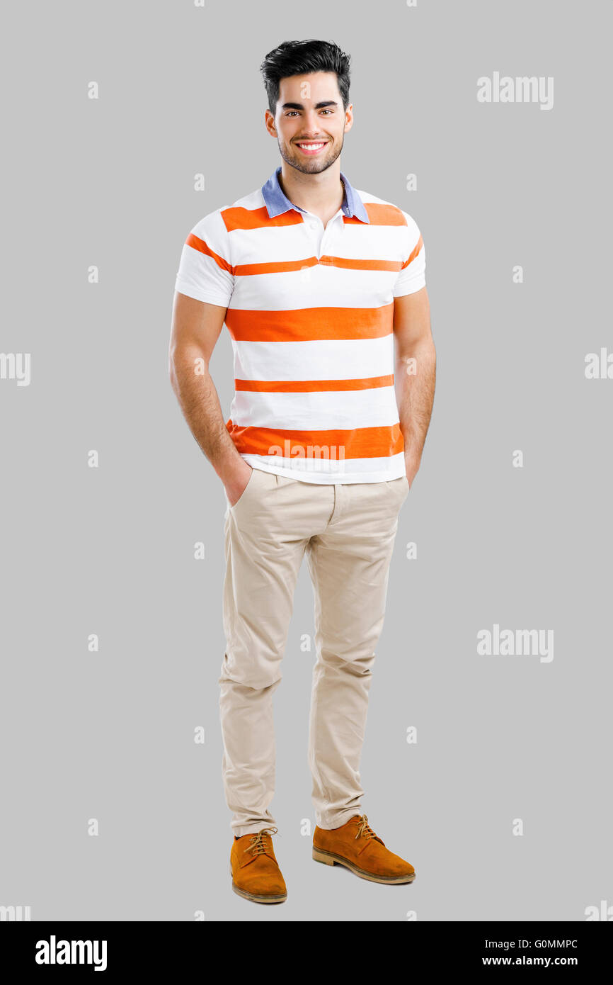 Full length portrait of happy handsome young man isolated over a gray ...