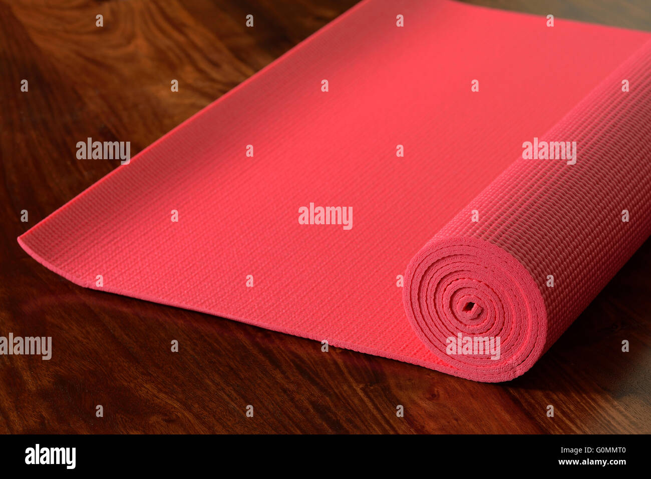 Yoga Mat on Wooden Floor Stock Photo