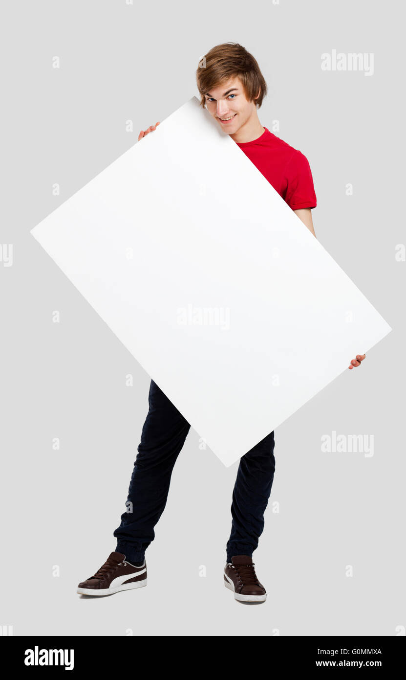 Portrait of a happy young man holding blank white card Stock Photo - Alamy