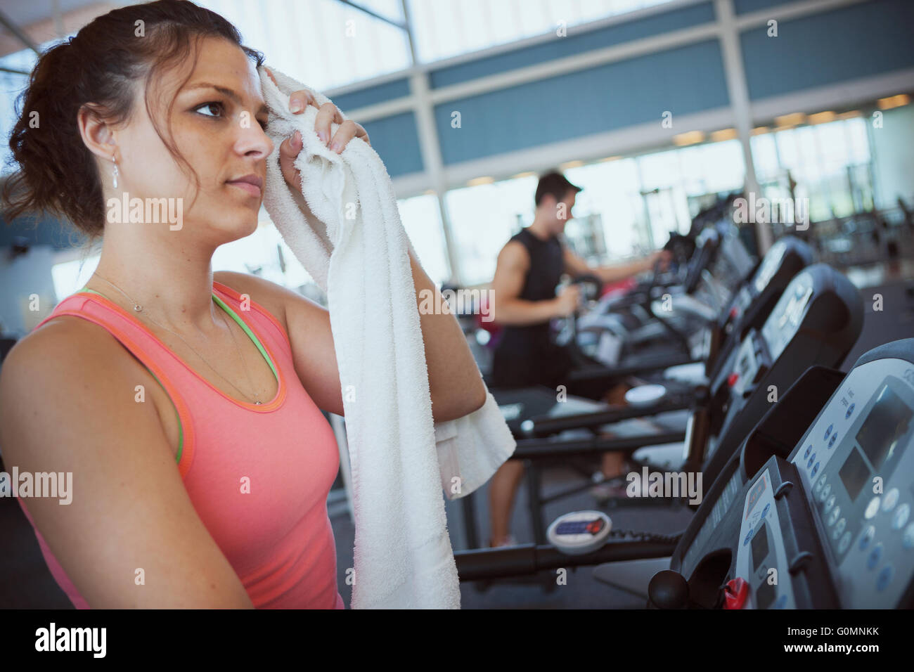 Series with man and woman at the gym, lifting weights, using the treadmill, etc. Stock Photo