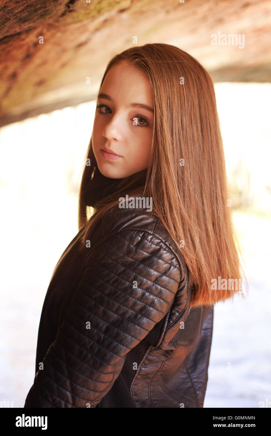 Beautiful teenage girl standing under a bridge Stock Photo