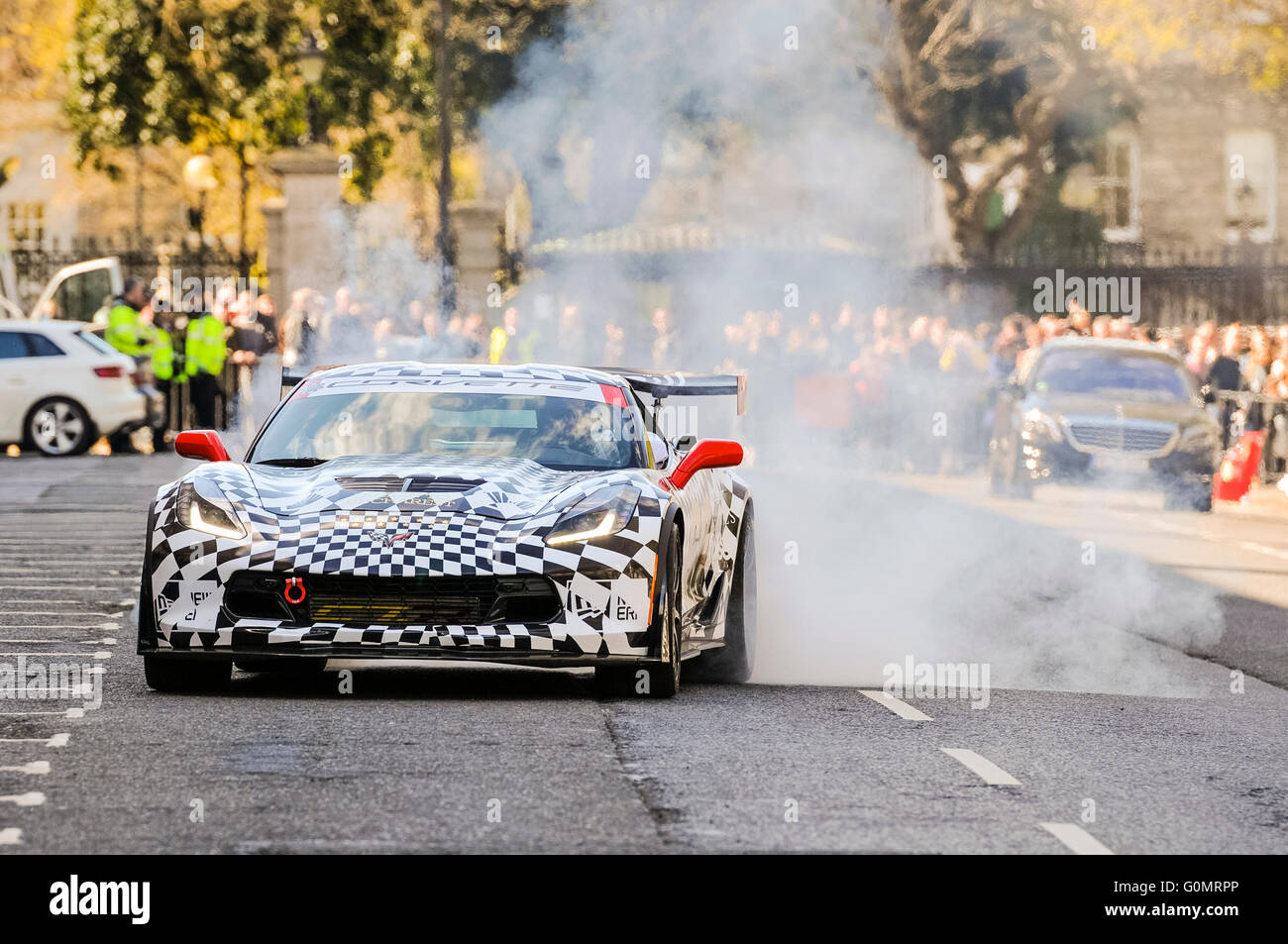DUBLIN, IRELAND. MAY 01 2016 - A Chevrolet Corvette creates a huge cloud of smoke by spinning its wheels as it arrives for the start of the Gumball 3000. Stock Photo