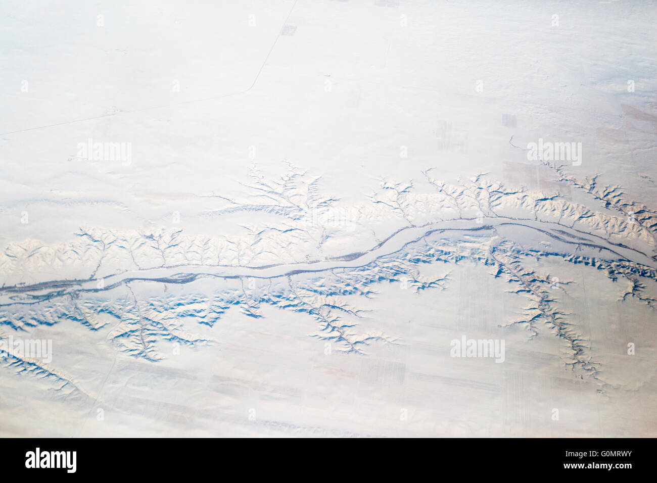 Dendritic river drainage pattern in snow covered prairie landscape, aerial view Stock Photo