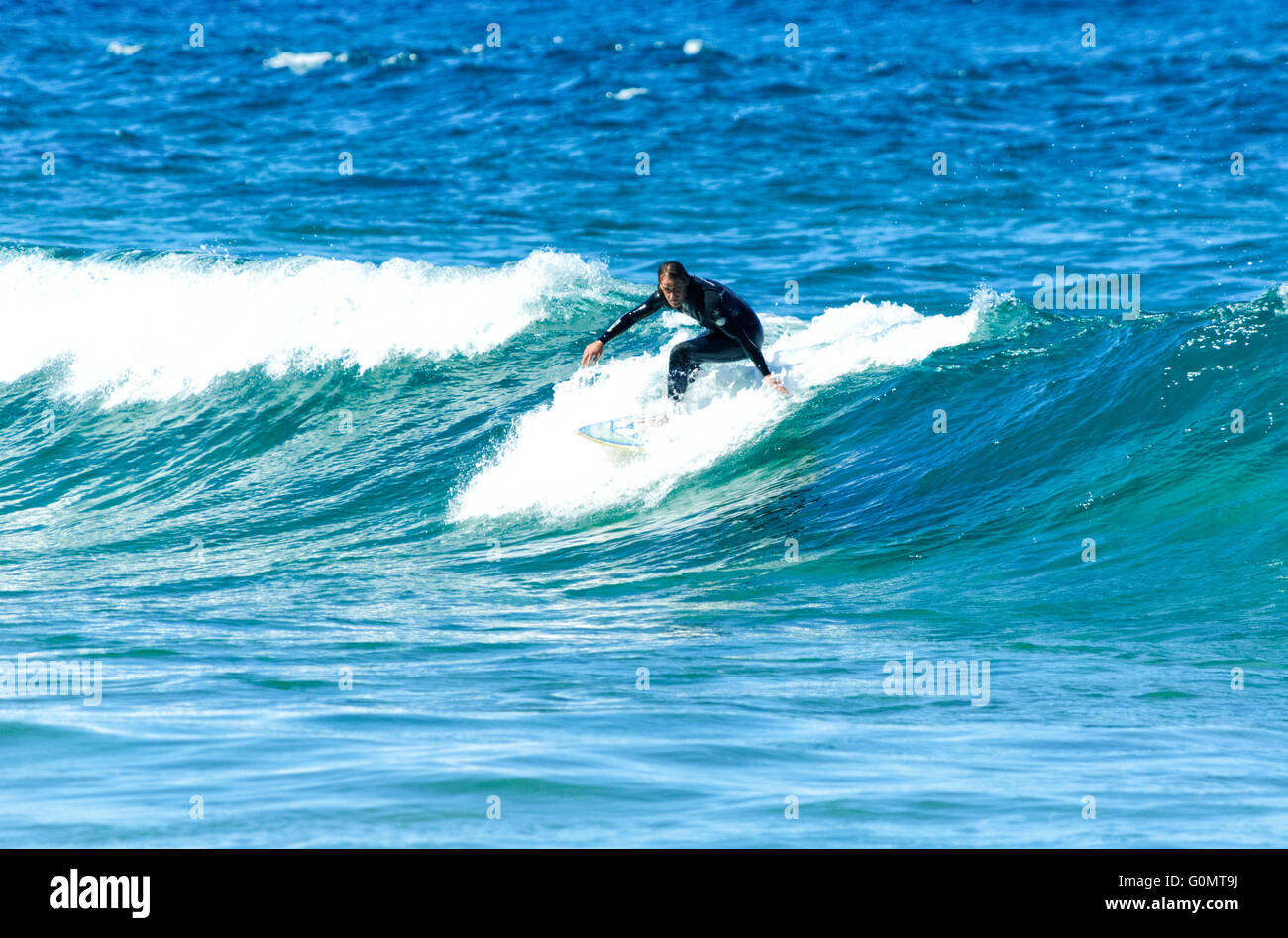 Surfers riding wave hi-res stock photography and images - Alamy