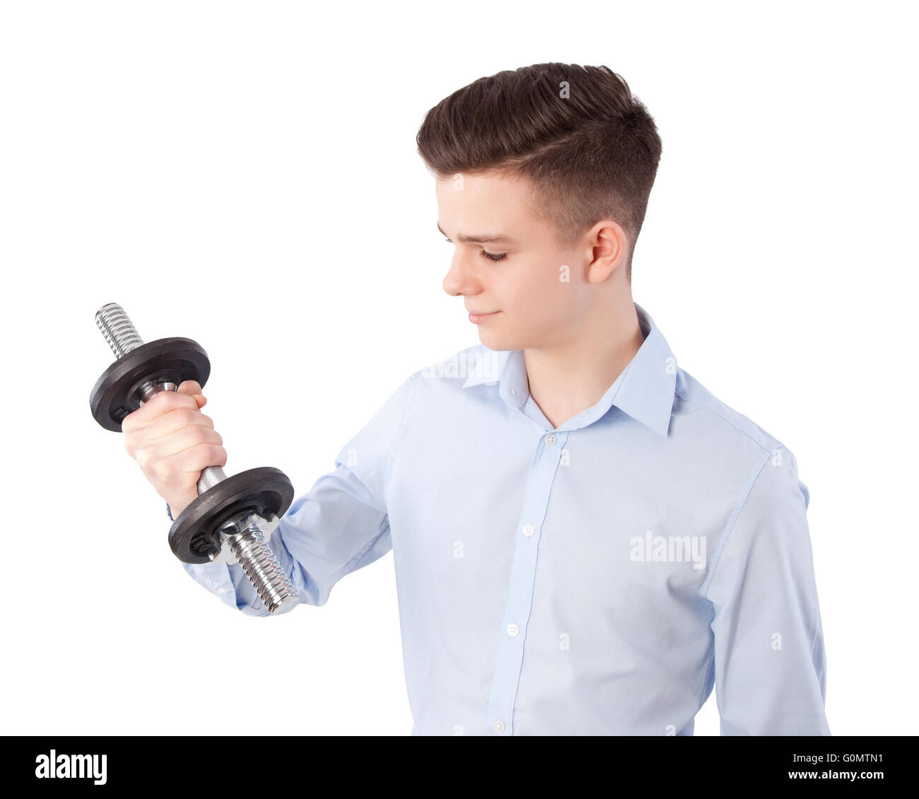 teenage boy exercising with dumbbell Stock Photo