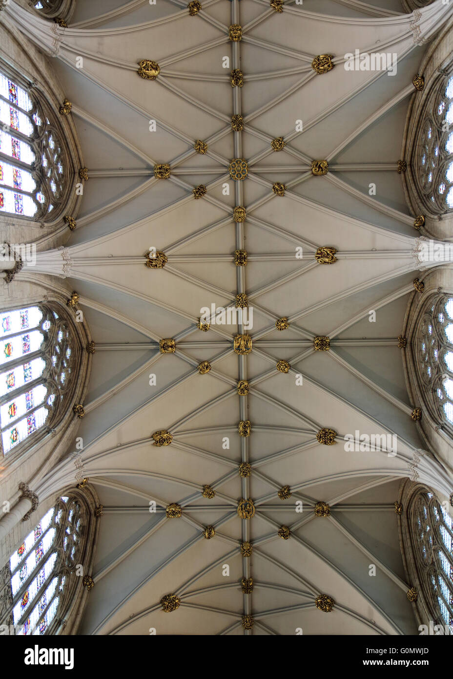 Vaulted ornate ceiling in York minster highly decorated with stained glass windows Stock Photo