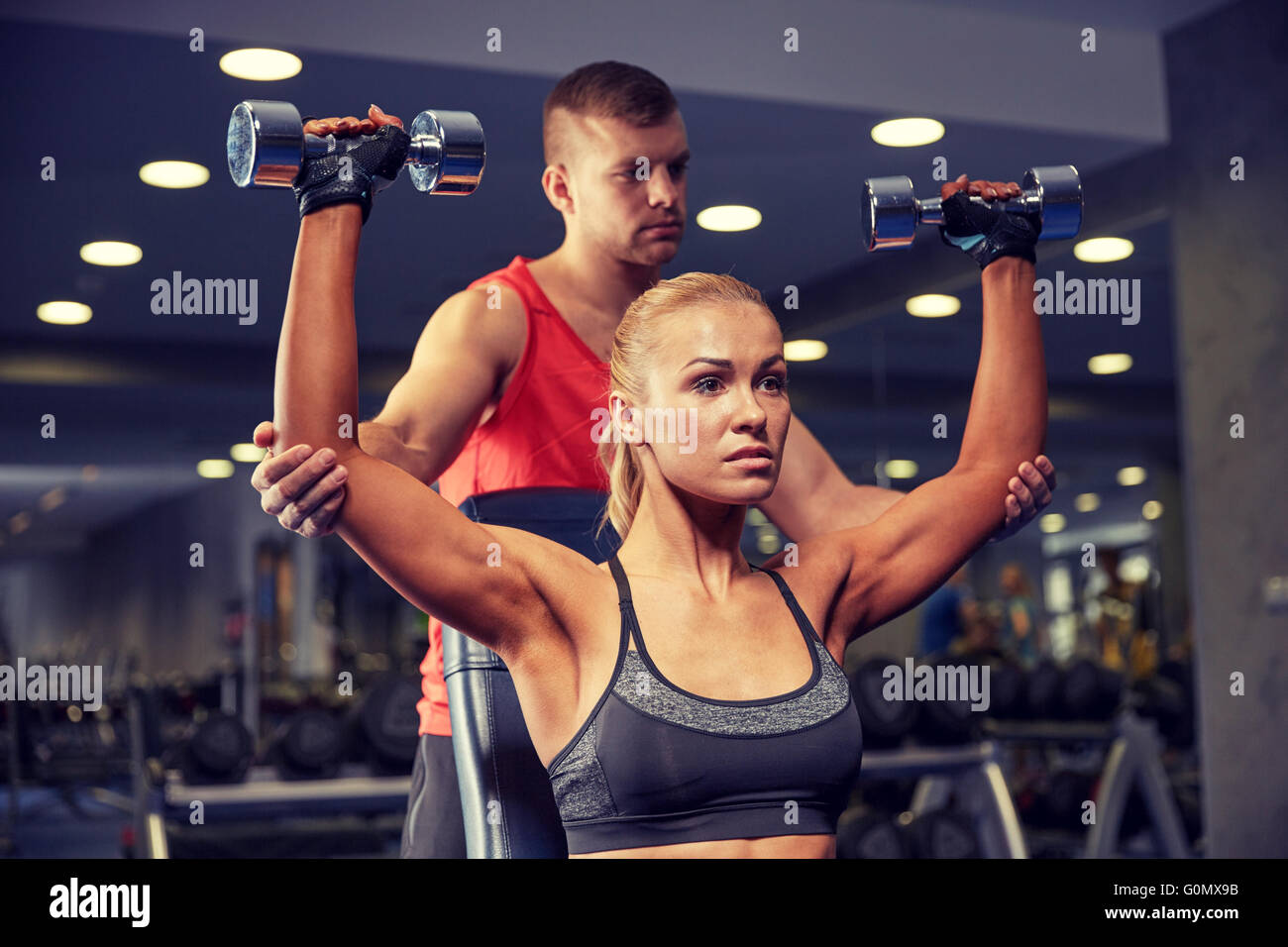 man and woman with dumbbells in gym Stock Photo - Alamy