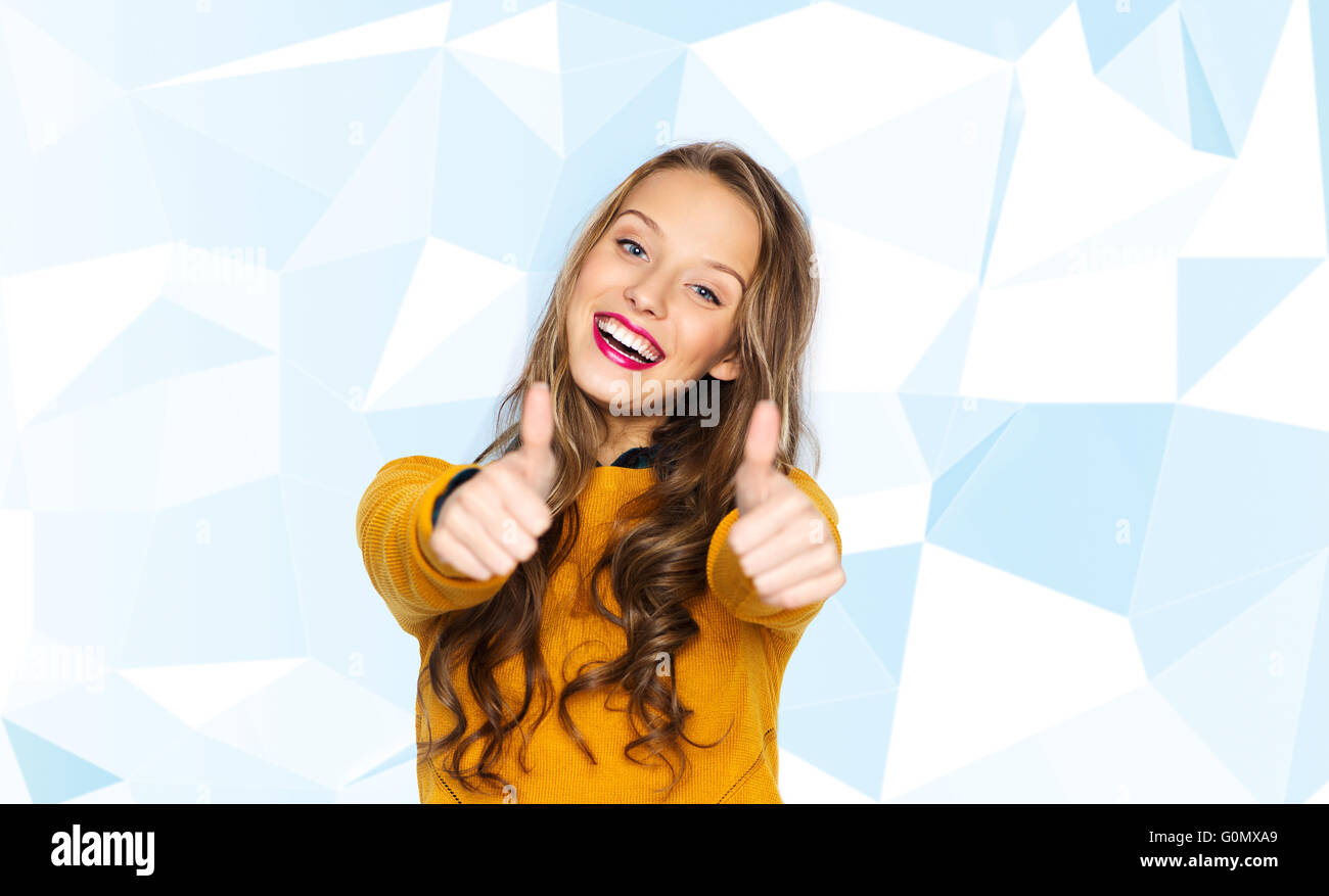 happy young woman or teen girl showing thumbs up Stock Photo - Alamy