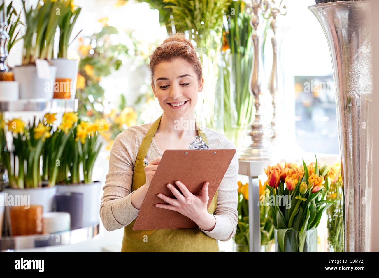 florist woman with clipboard at flower shop Stock Photo - Alamy