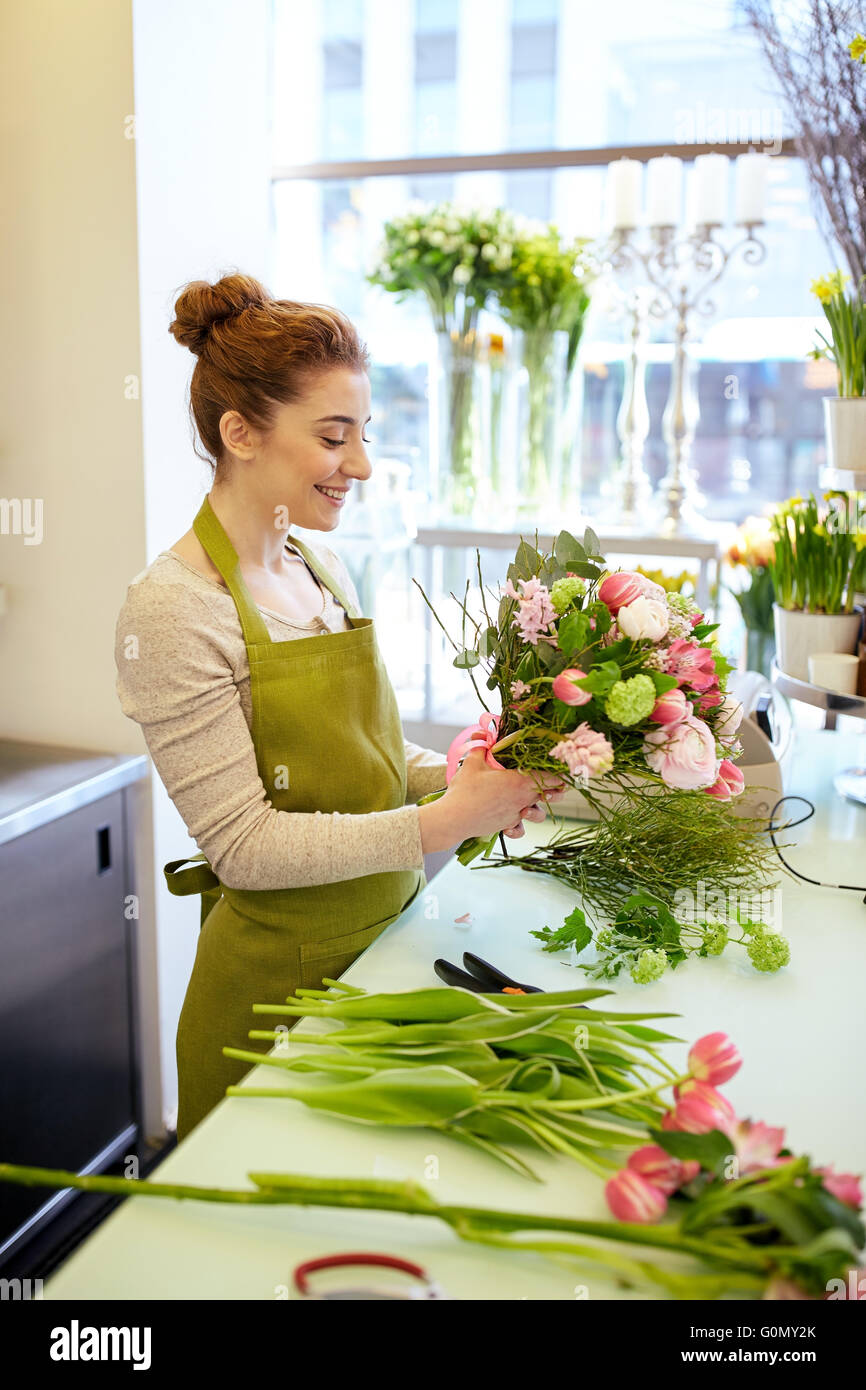 smiling florist woman making bunch at flower shop Stock Photo - Alamy