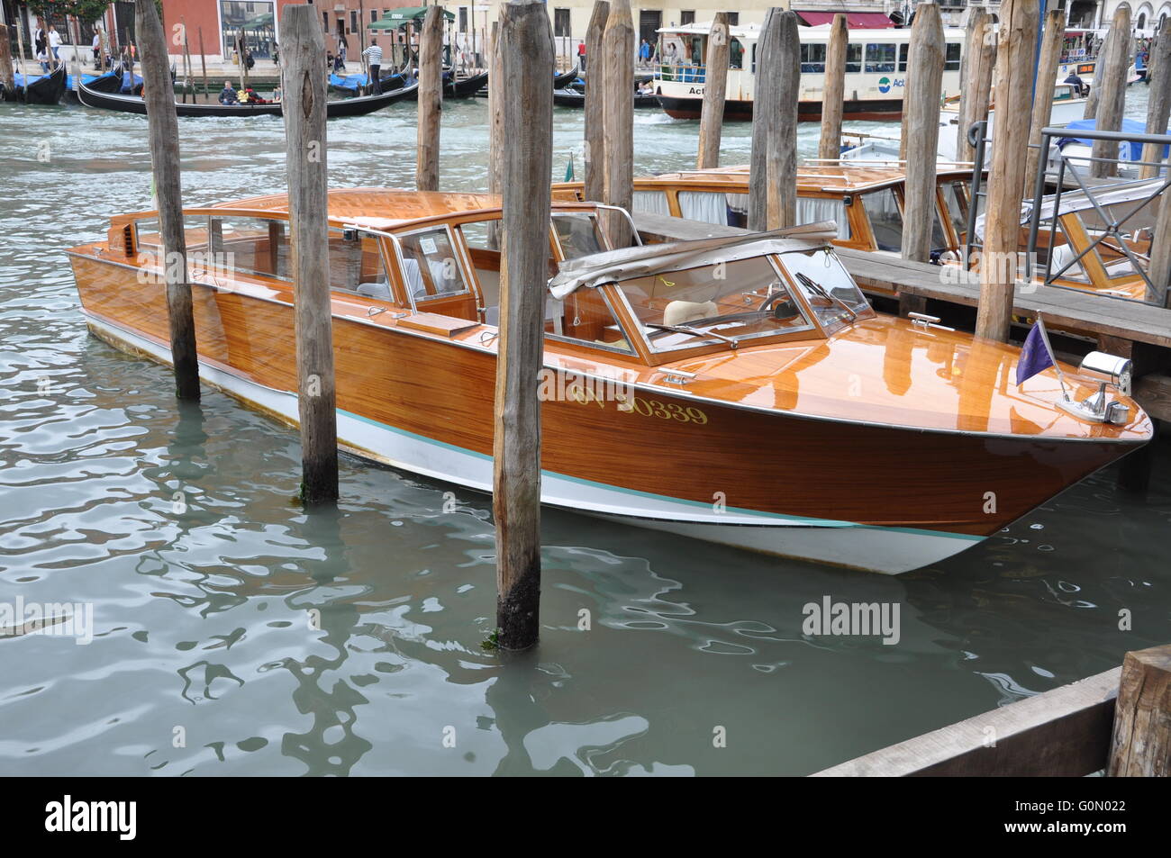 Classic mahongany Riva Limousine in a boat slip in Venice Stock Photo