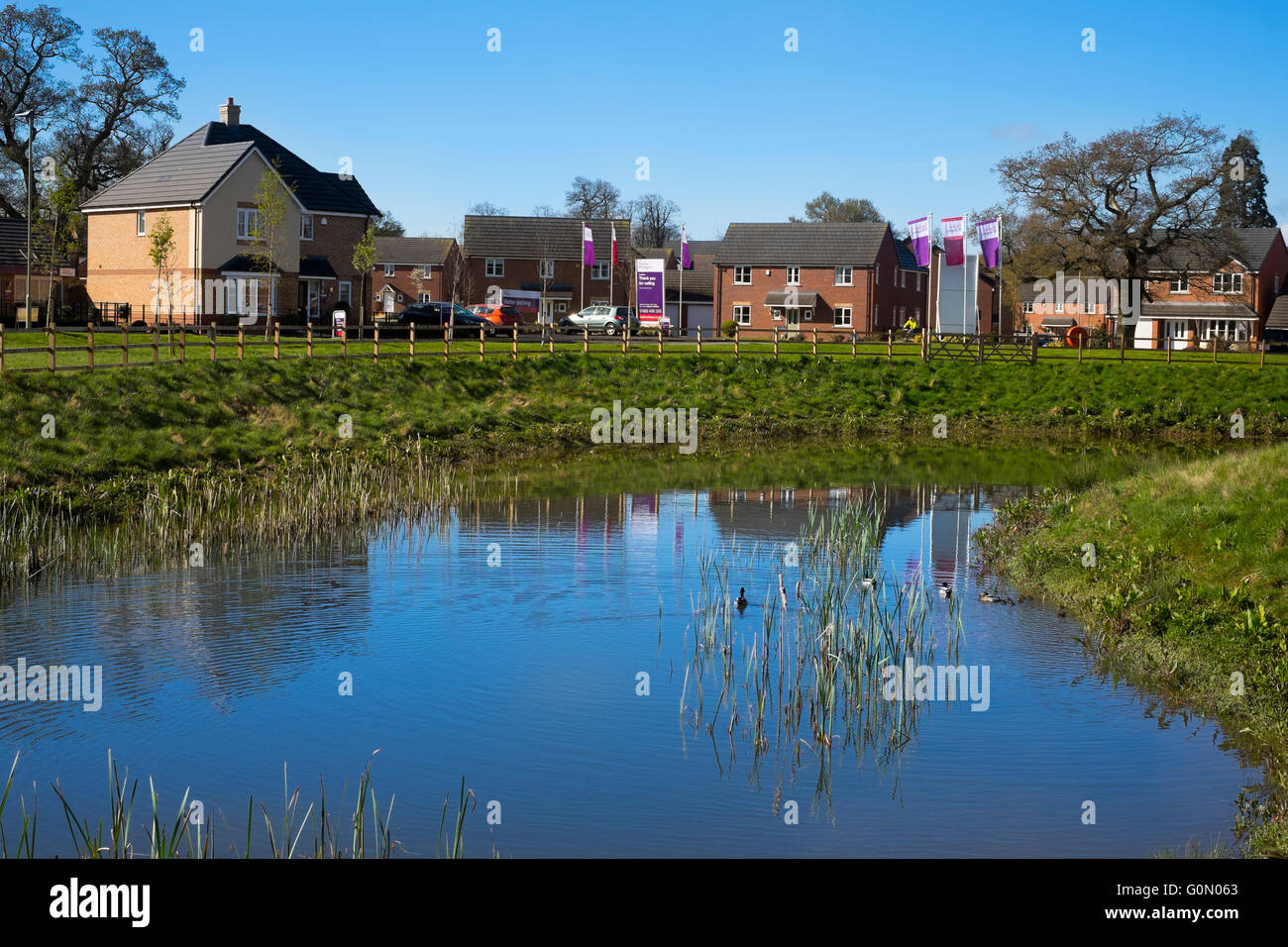 A pool and houses on a new estate at Shifnal, Shropshire, England, UK
