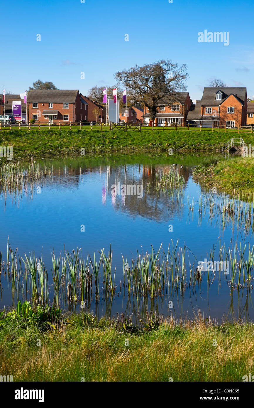 A pool and houses on a new estate at Shifnal, Shropshire, England, UK