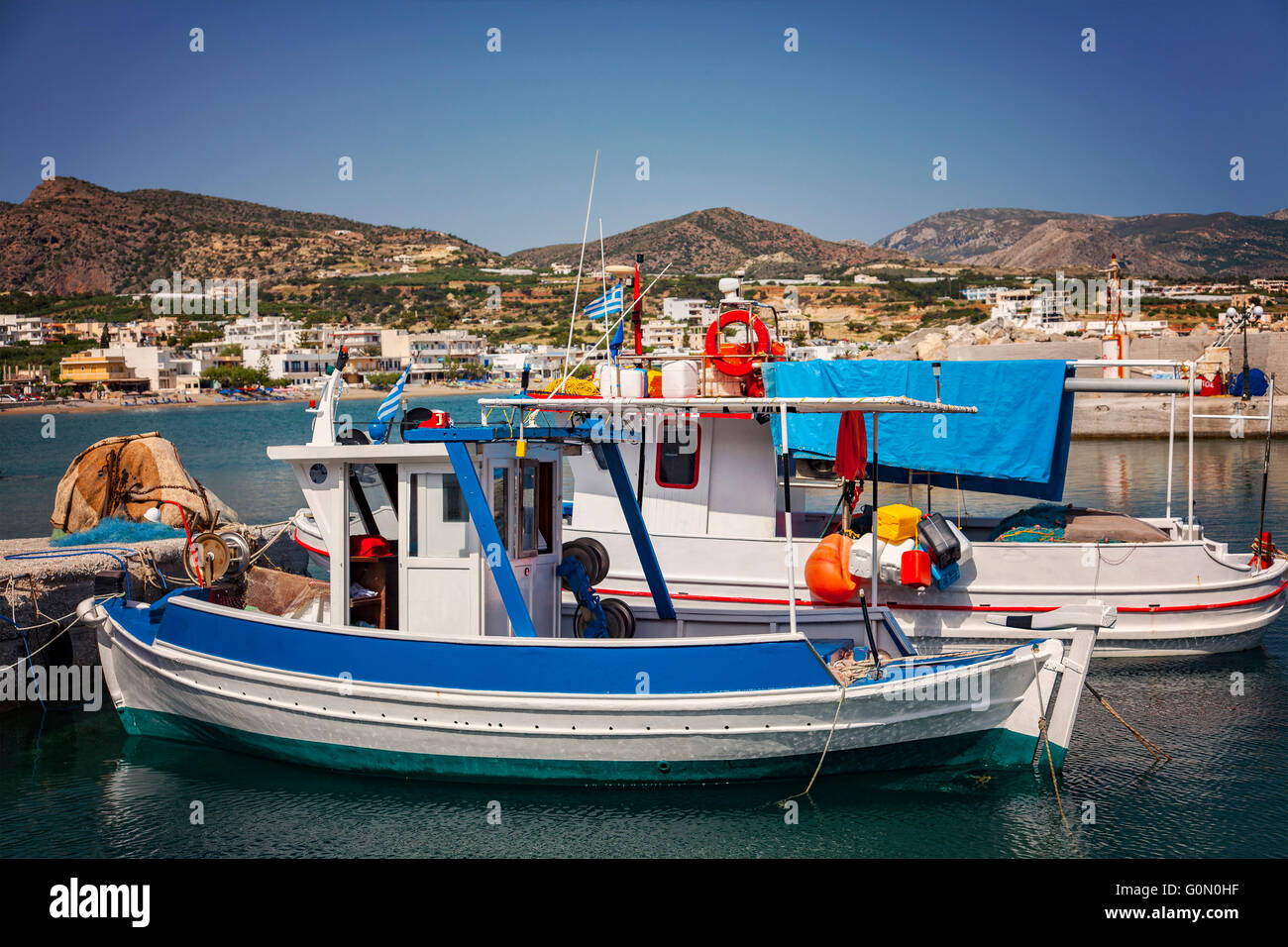 Image of small fishing boats in the village port. Makrigialos, Crete. Stock Photo