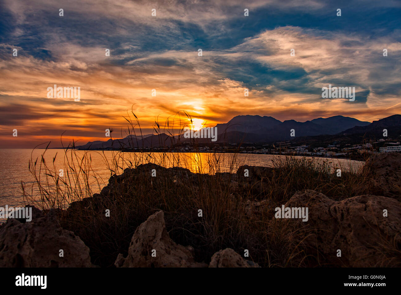 Image of dramatic rocky sunset landscape. Crete, Greece. Stock Photo