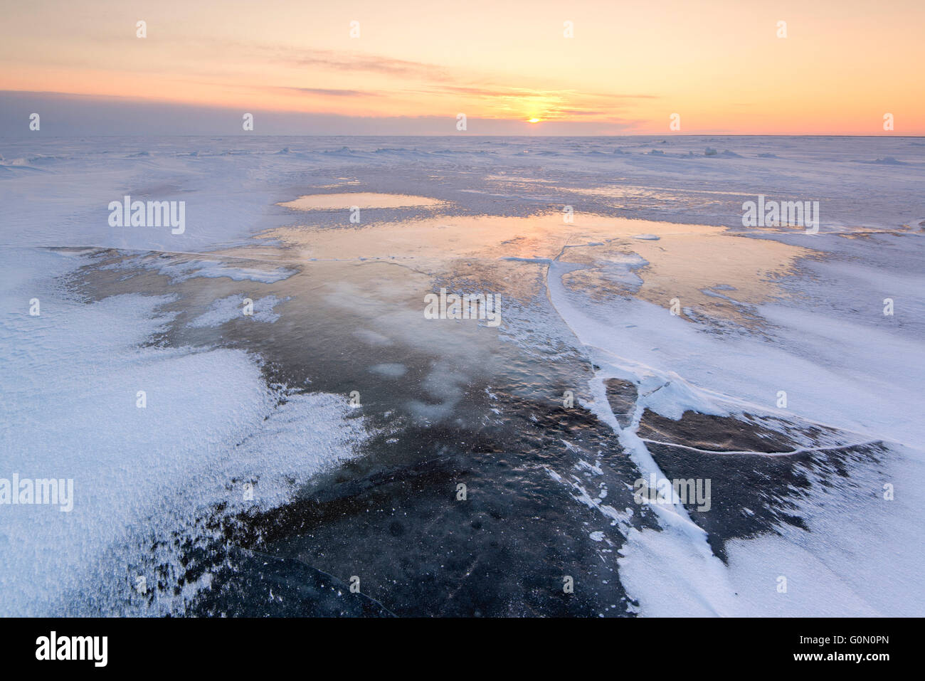 Frozen lake in winter at sunrise Stock Photo