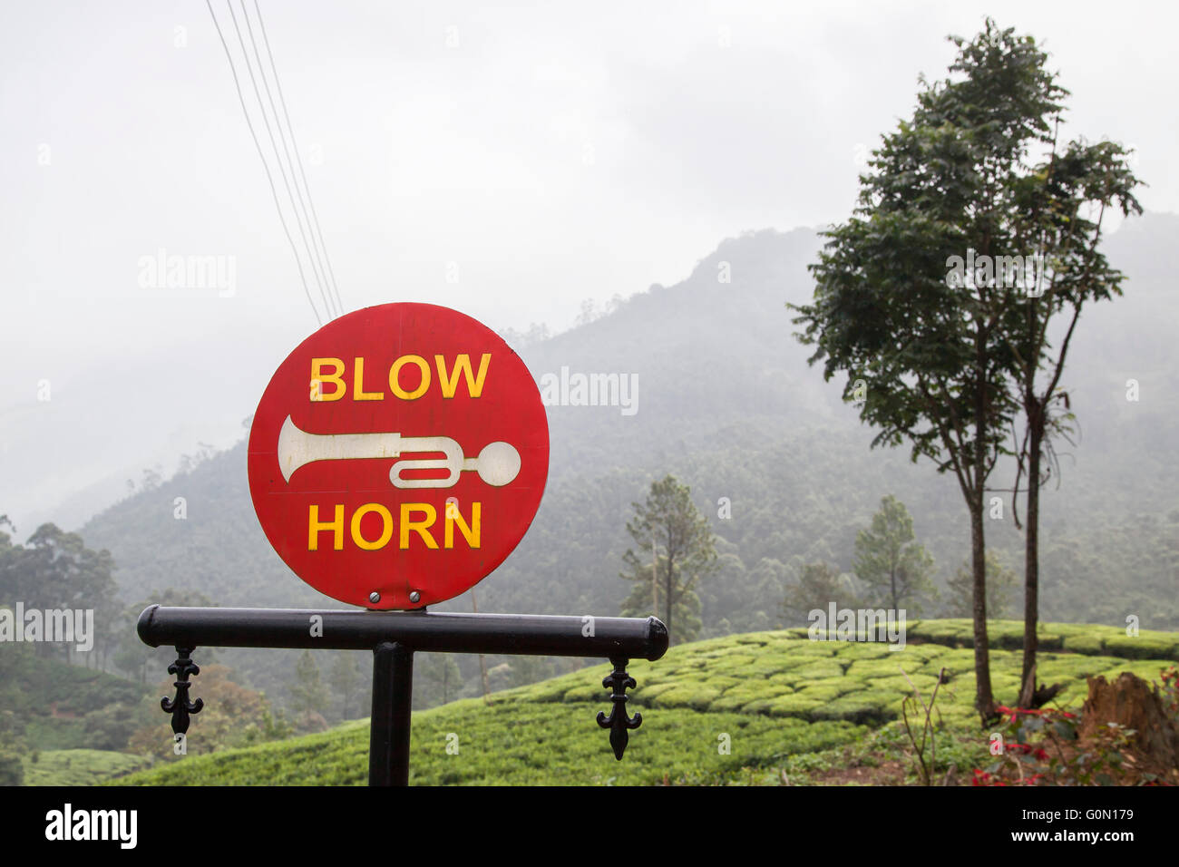 A 'Blow Horn' sign on a tea plantation in Munnar, Kerala, India Stock