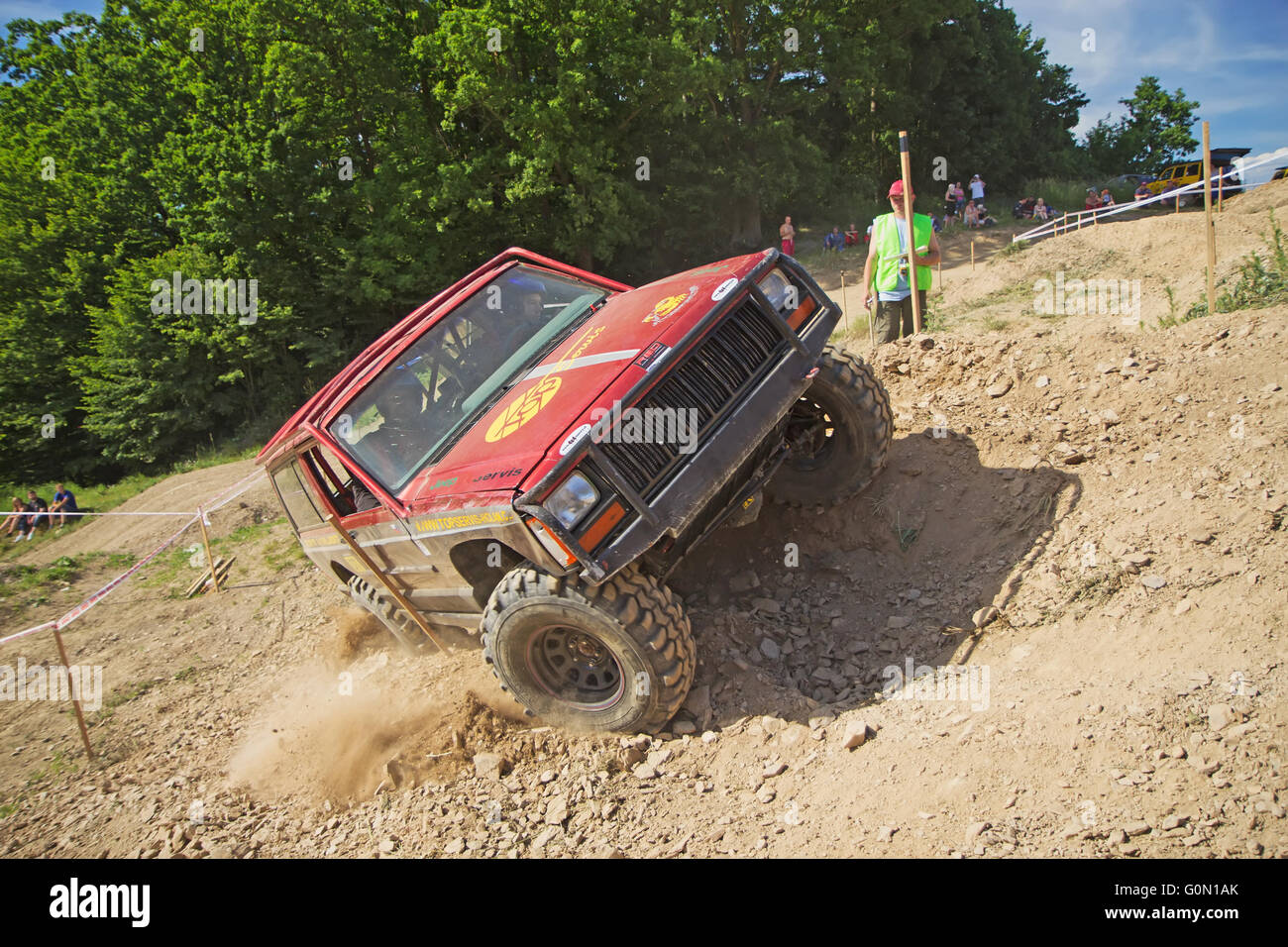 Red off road car is in lateral tilt Stock Photo Alamy