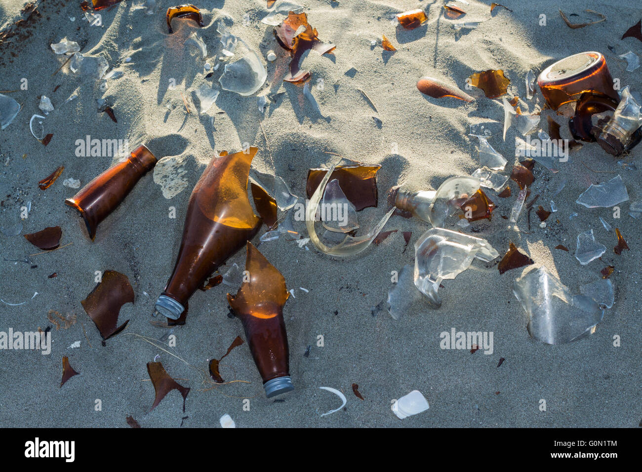 Broken glass bottles left in the sand Stock Photo Alamy