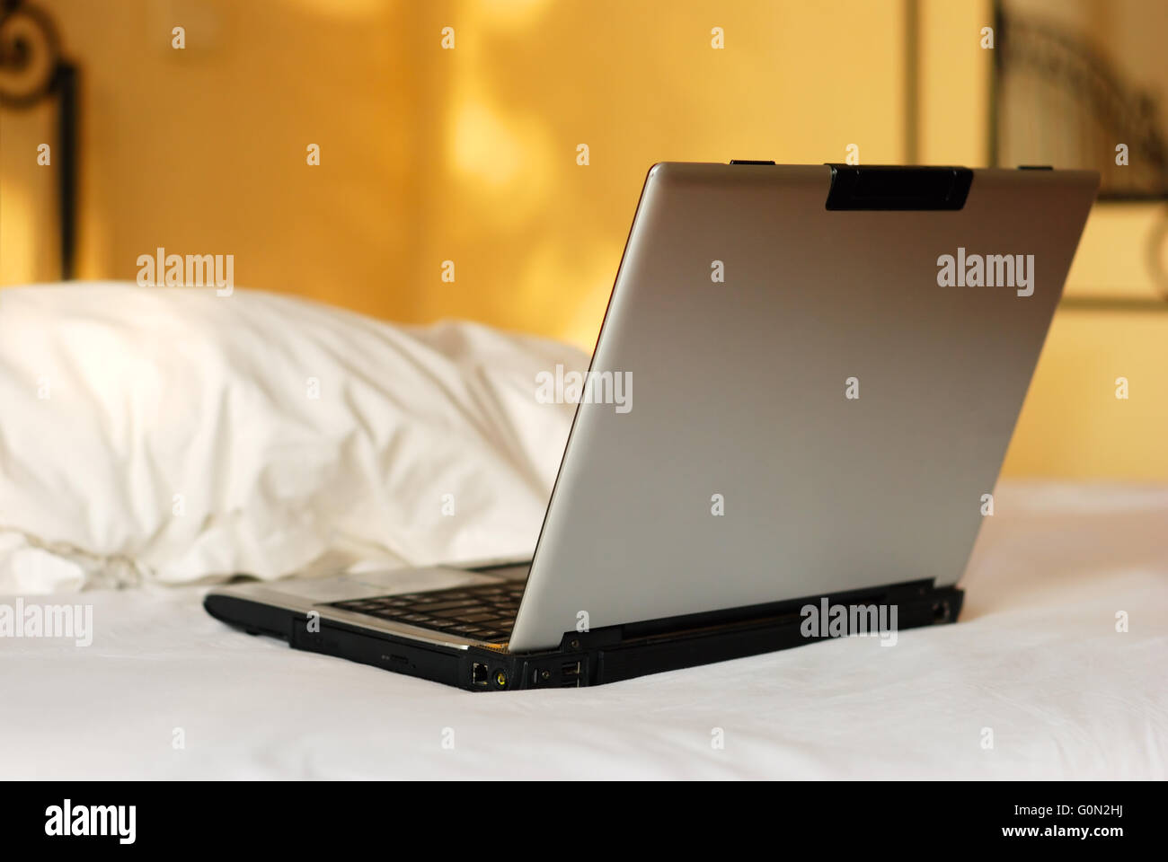 open laptop on a bed Stock Photo Alamy