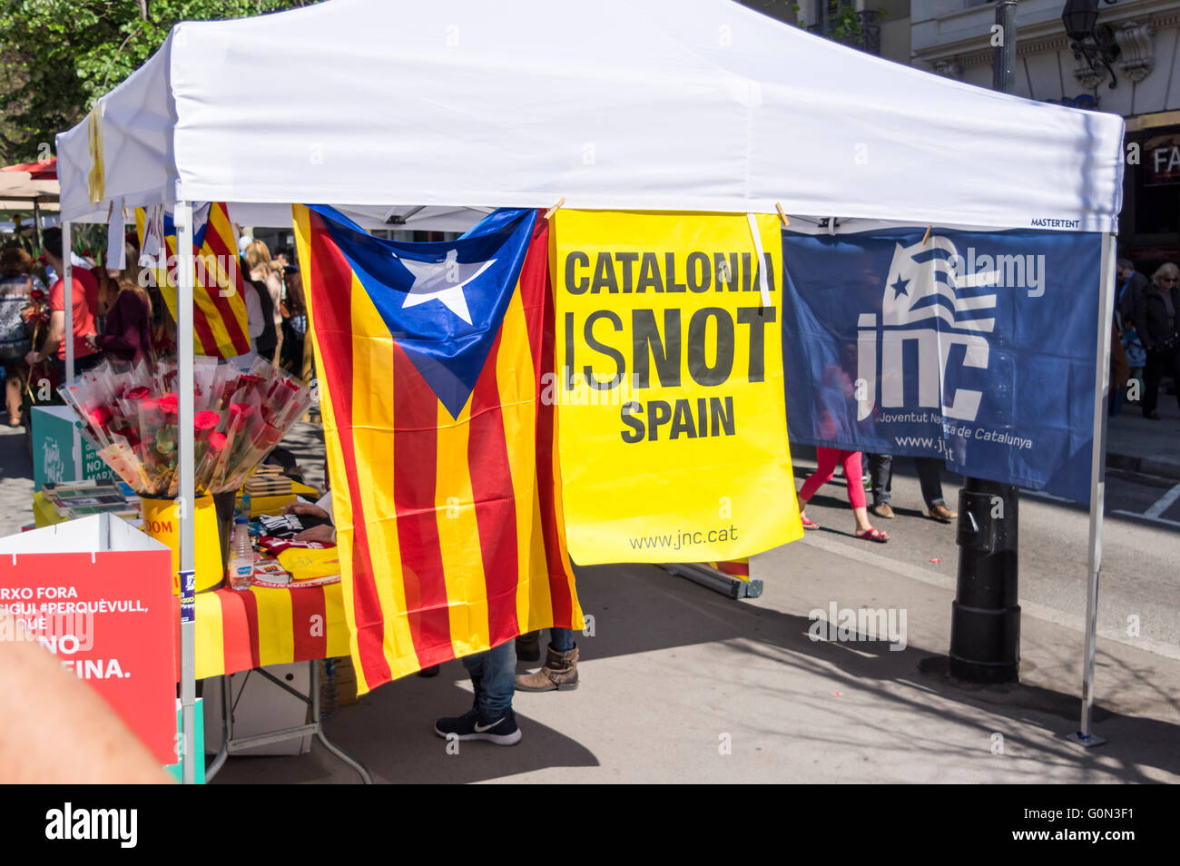 'Catalonia is not Spain' banner at a booth of JNC, a party supporting Catalan independence from Spain. Barcelona, 23 April 2016. Stock Photo