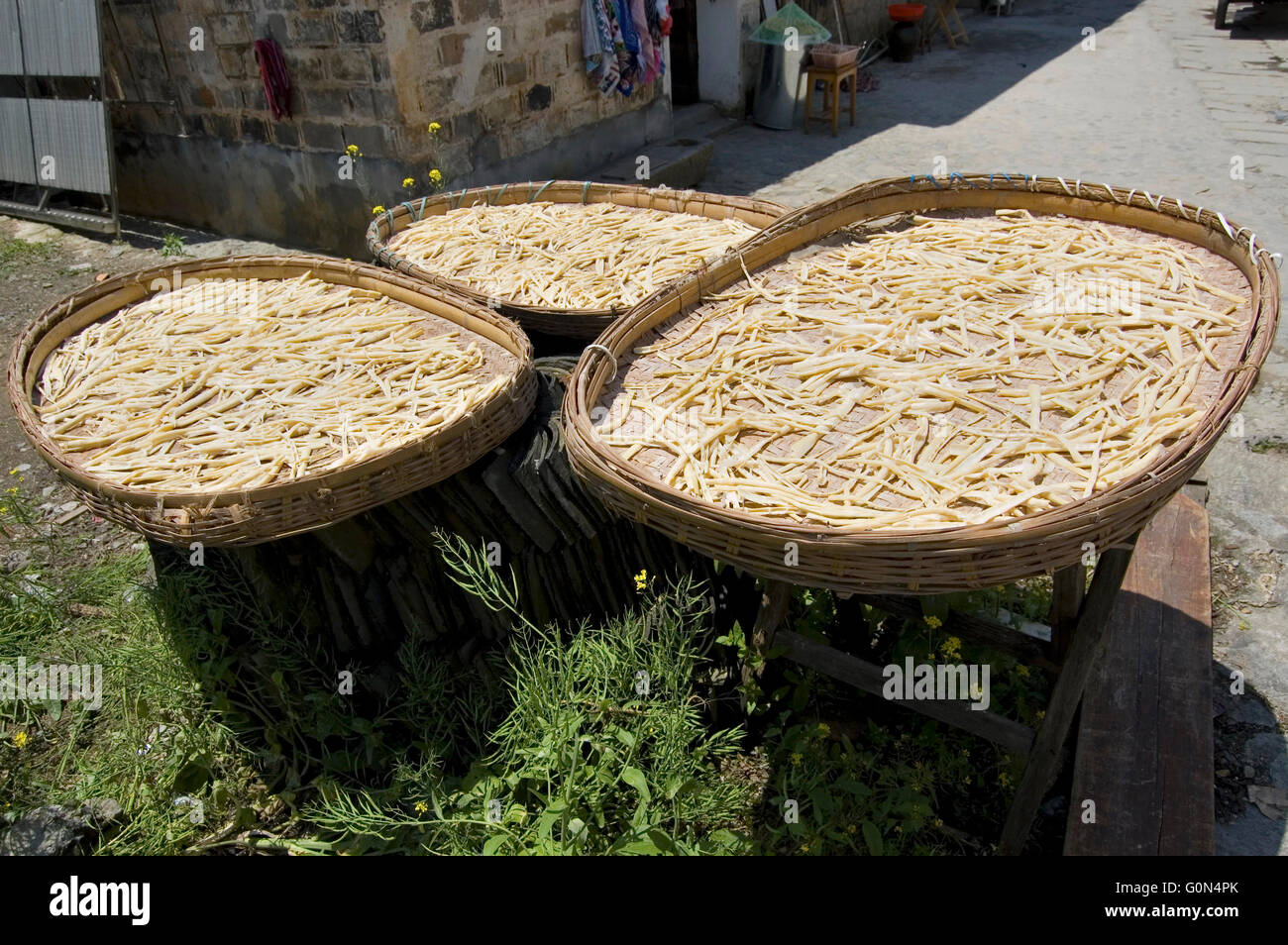 Bamboo shoots spread out to dry at the world heritage town of Hongcun Stock Photo