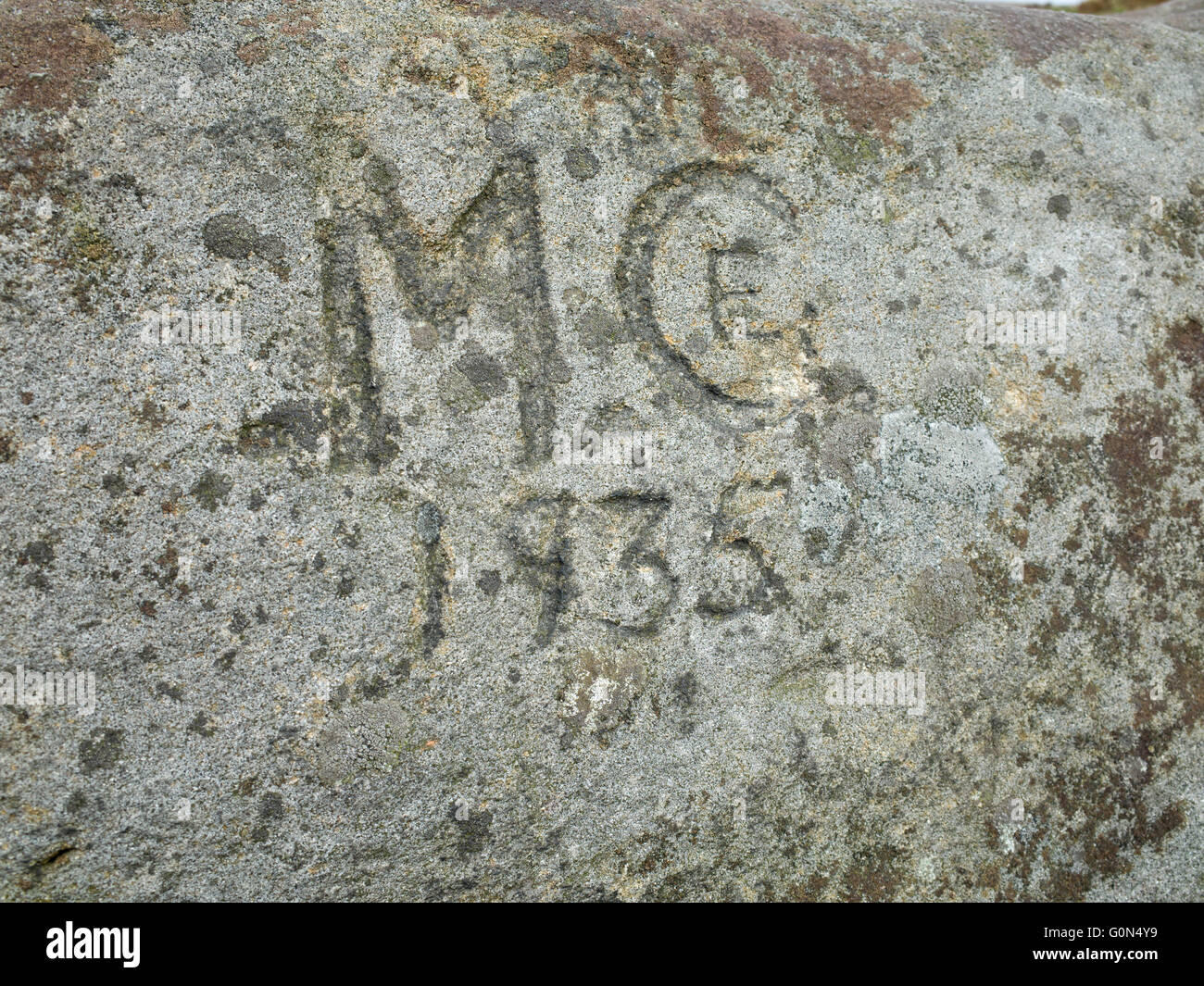Old graffiti, names carved in stone. Found at the top of Embsay Crag Stock Photo