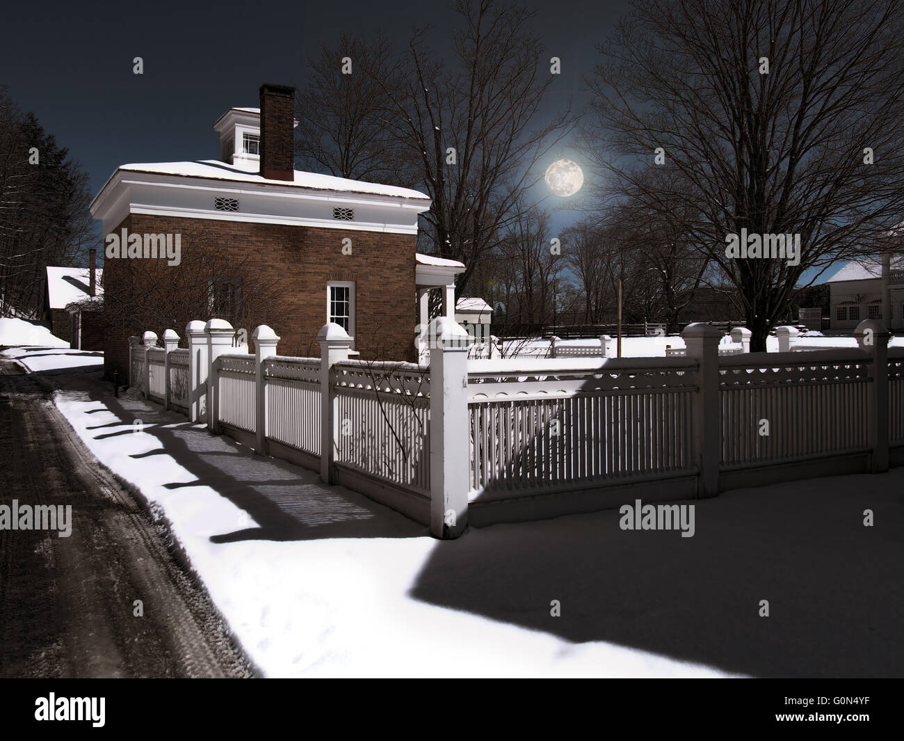 small rural town at nighttime in winter with full moon Stock Photo