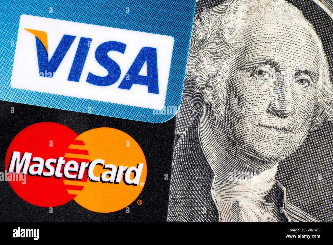 Visa and MasterCard logo on credit cards on one dollar bill with George Washington portrait Stock Photo