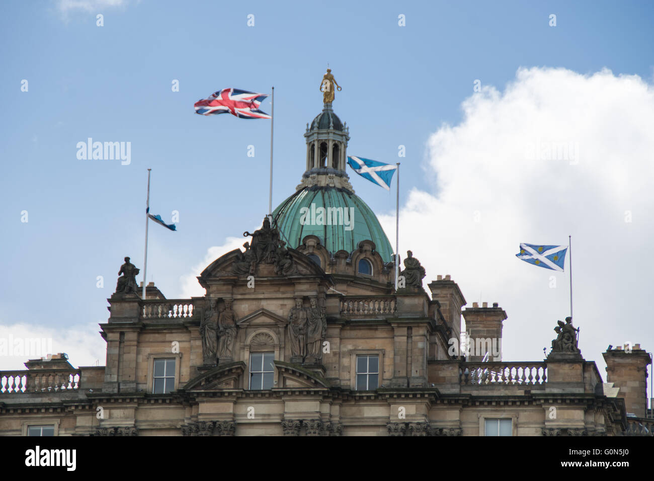 Top part of the Bank Of Scotland building with Saltire and Union Jack flags -  Edinburgh, Scotland Stock Photo