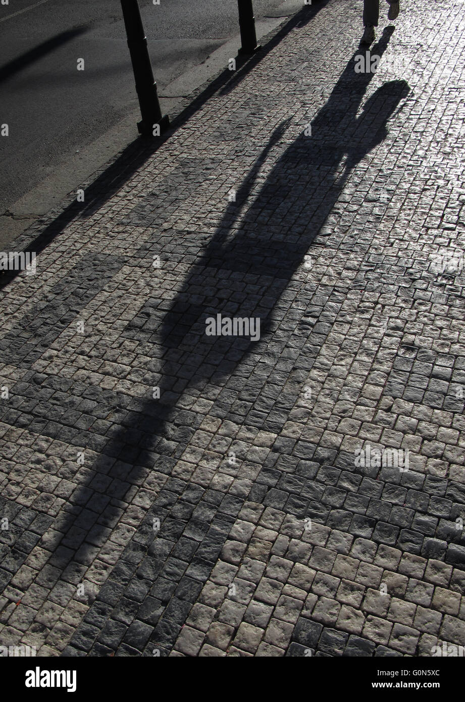 man´s shadow on sidewalk, Prague - Letna, Czech Republic Stock Photo