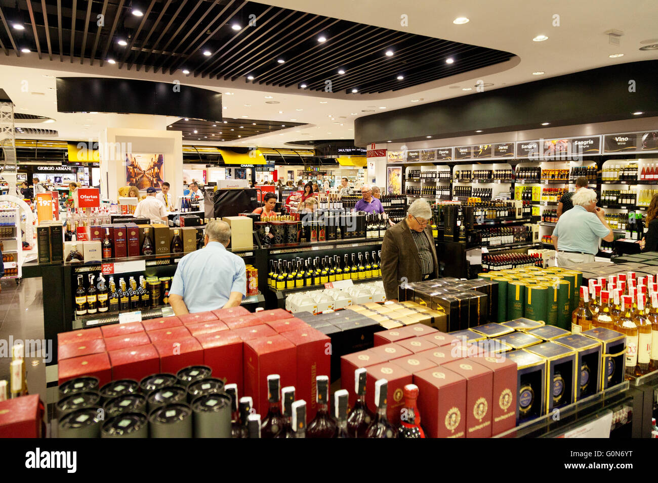 People shopping for duty free alcohol in the Duty Free shop, Marbella airport departure lounge, Marbella, Andalusia Spain Europe Stock Photo
