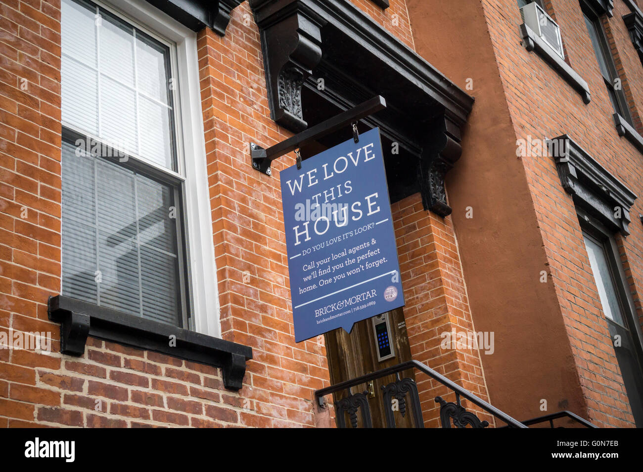 A sign hanging from a building in Williamsburg, Brooklyn in New York on