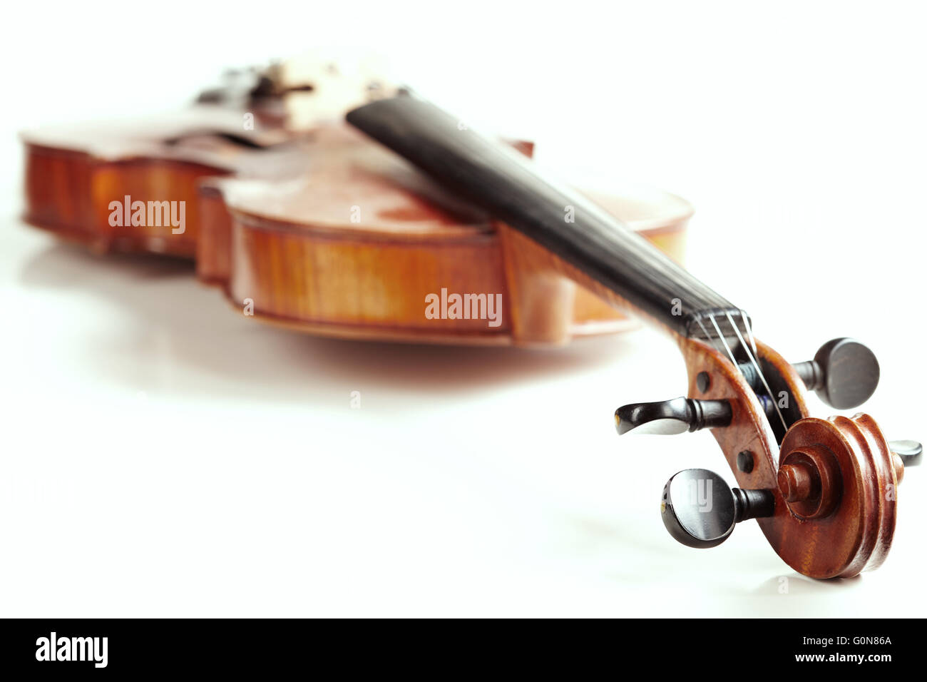 aged handmade violin on white background Stock Photo