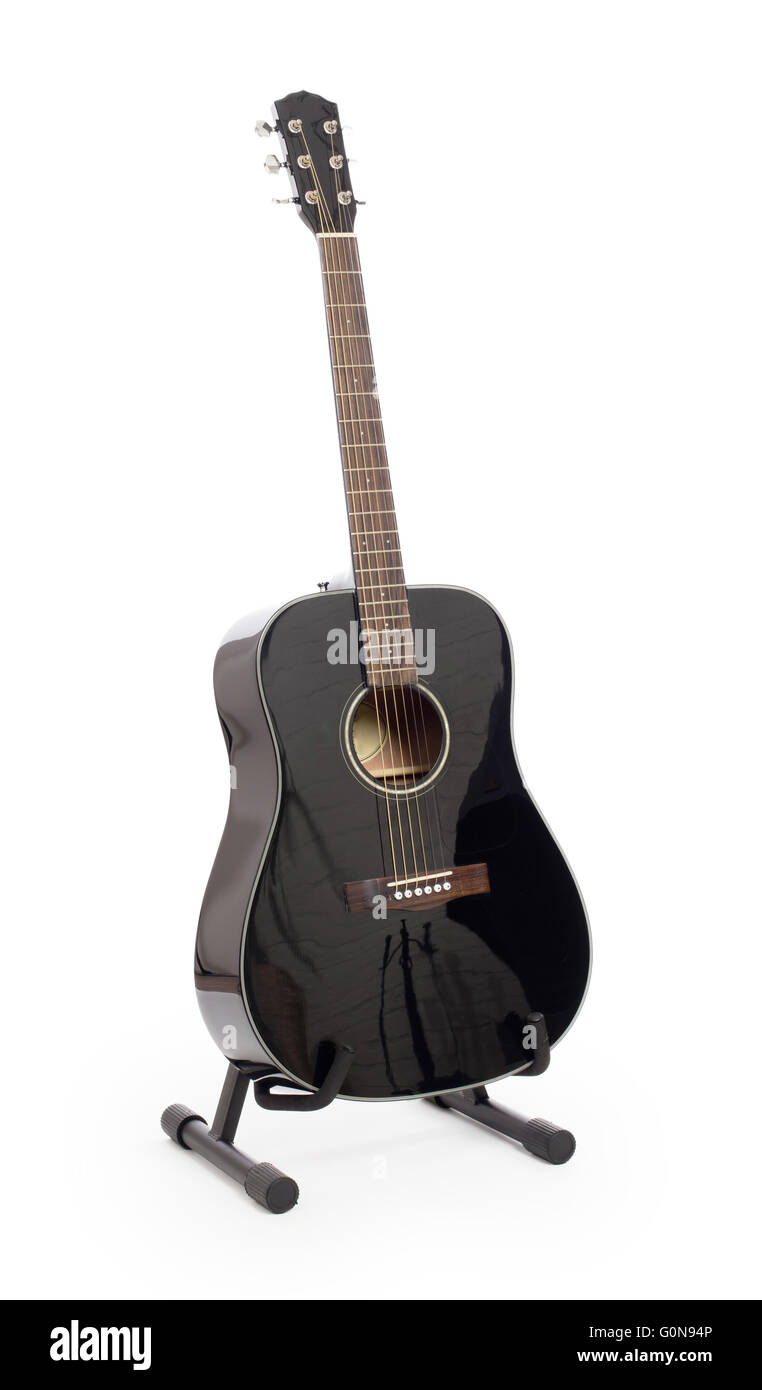 Black acoustic guitar on stand, isolated on a white background Stock Photo