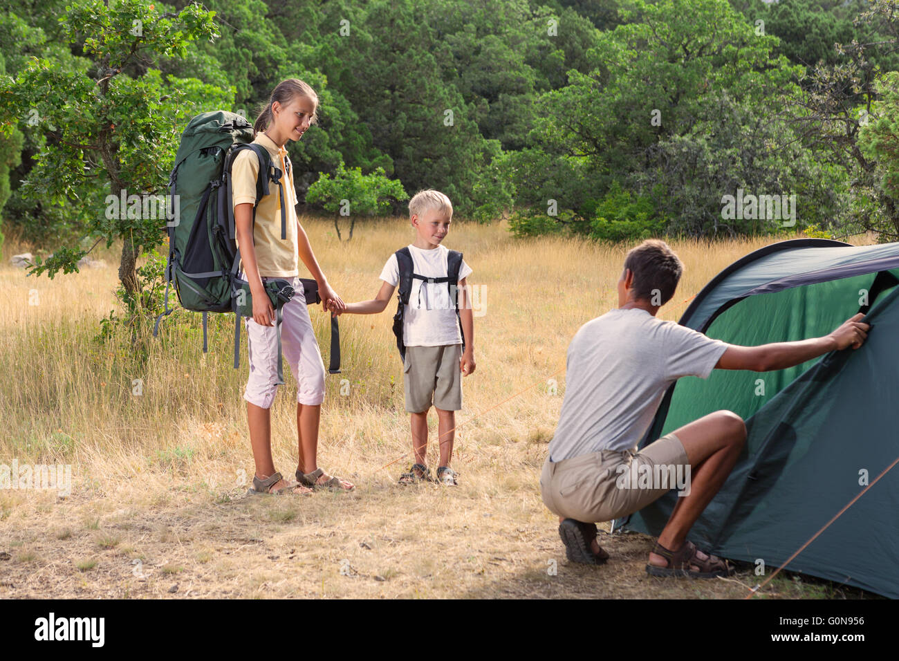 Father with children near tent Stock Photo