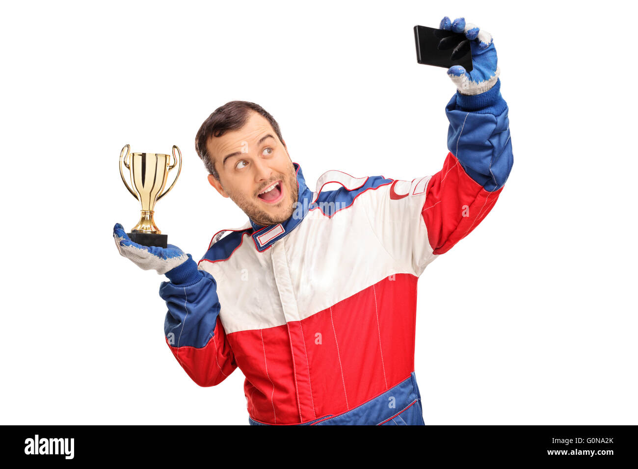 Joyful car racing champion holding a trophy and taking a selfie isolated on white background Stock Photo