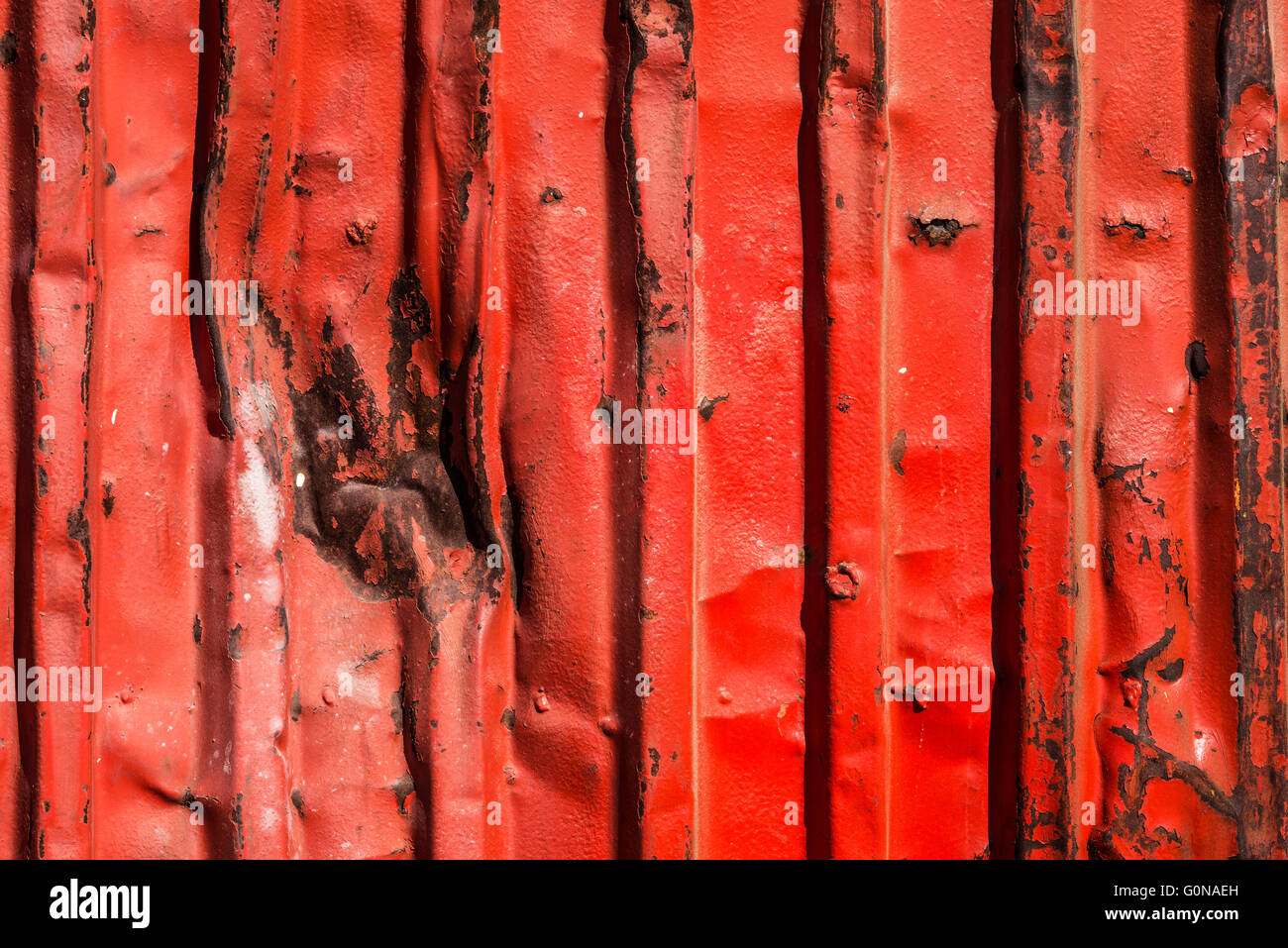Red rusty container with blows as background Stock Photo